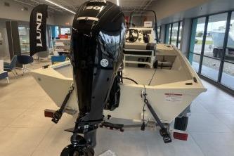 2026 Crestliner 1860 Retriever CC boat with outboard motor in showroom.