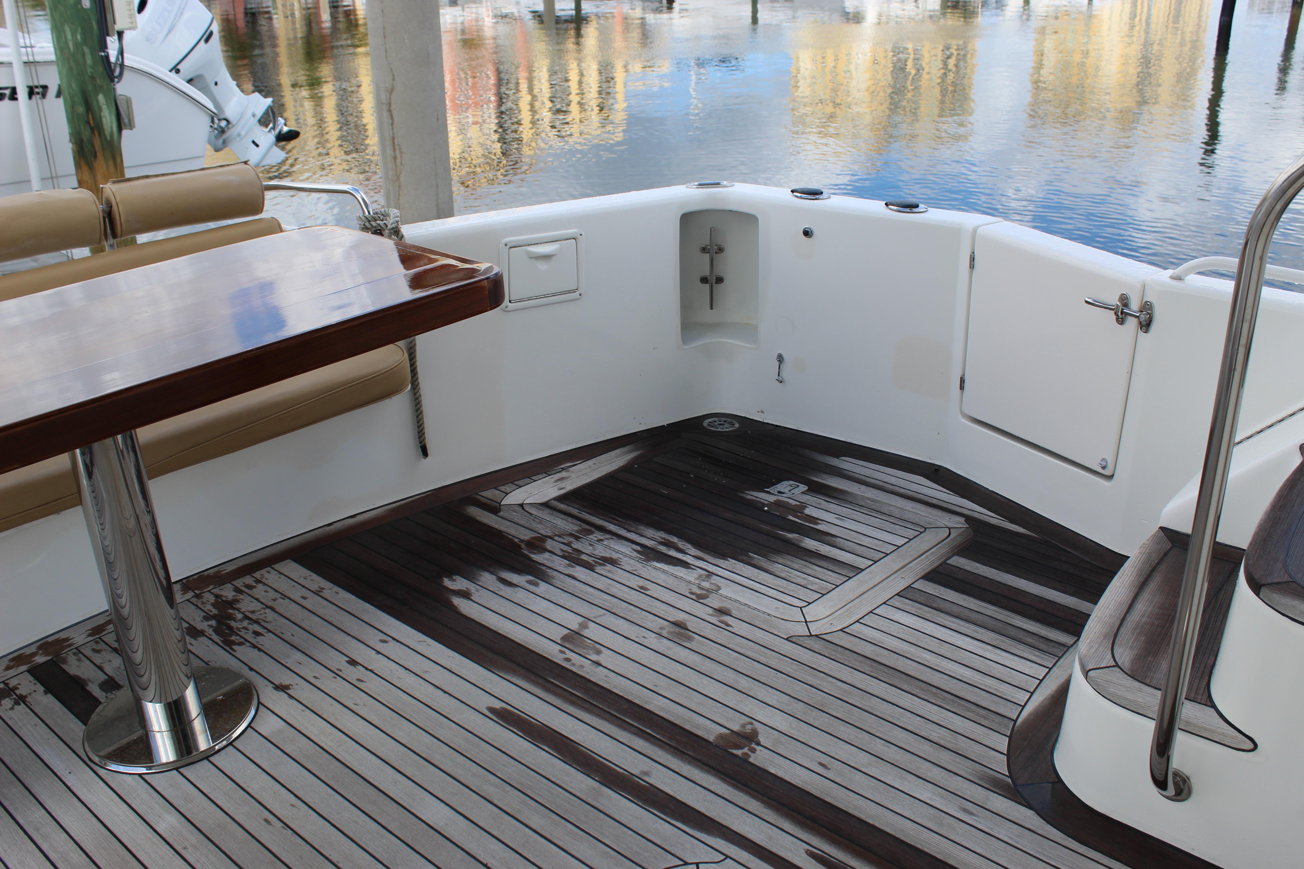 2003 Ocean Yachts 65 Odyssey deck with wooden flooring and seating area.
