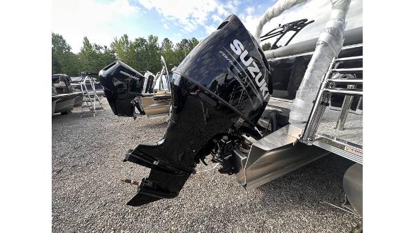 2025 Tahoe Pontoon LTZ Cruise with Suzuki outboard motor in a gravel lot.