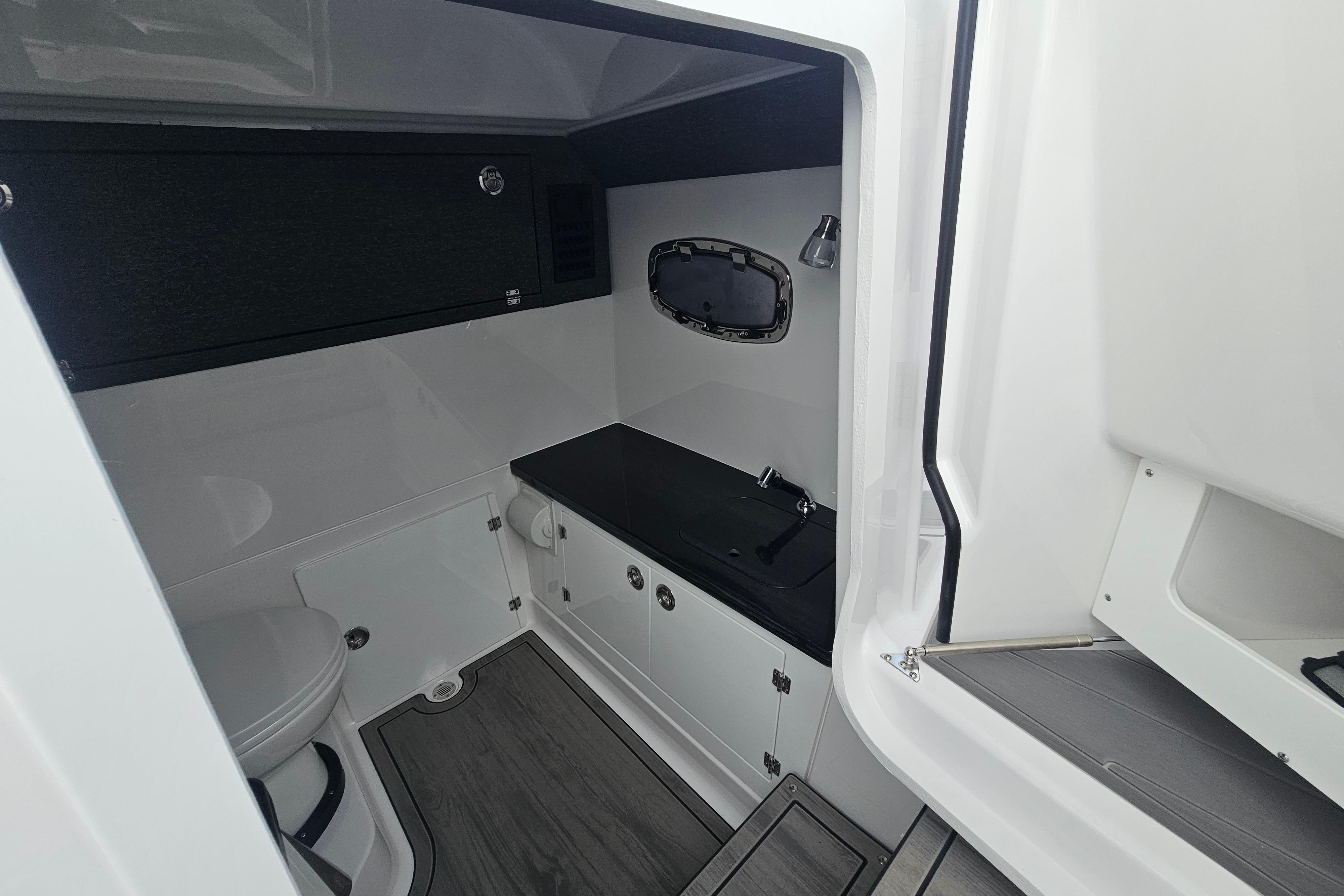 Interior of 2026 Monterey Elite 27 OB boat bathroom with modern fixtures.