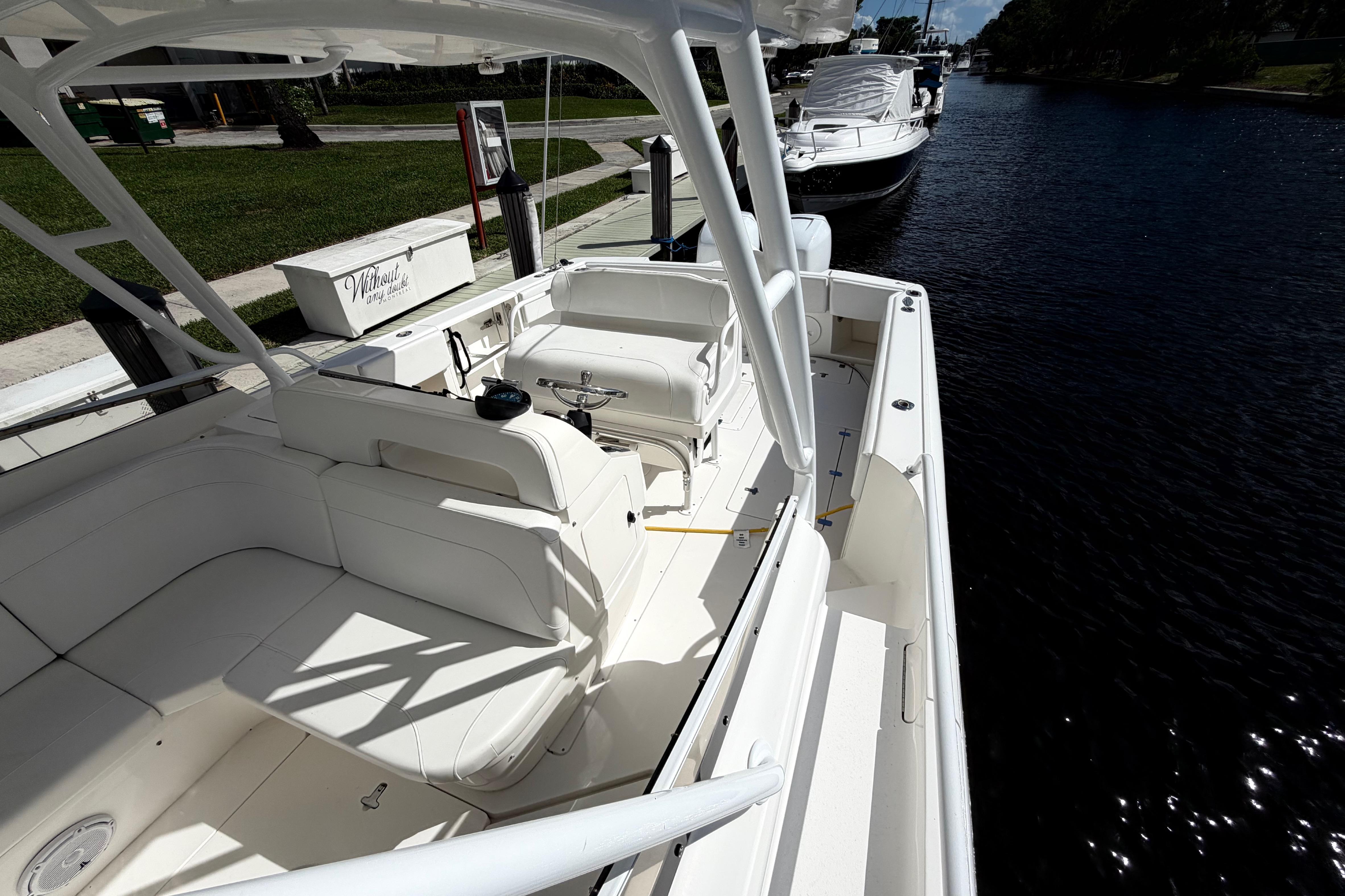 2008 Intrepid 350 Center Console boat docked on a sunny day, showcasing spacious seating.