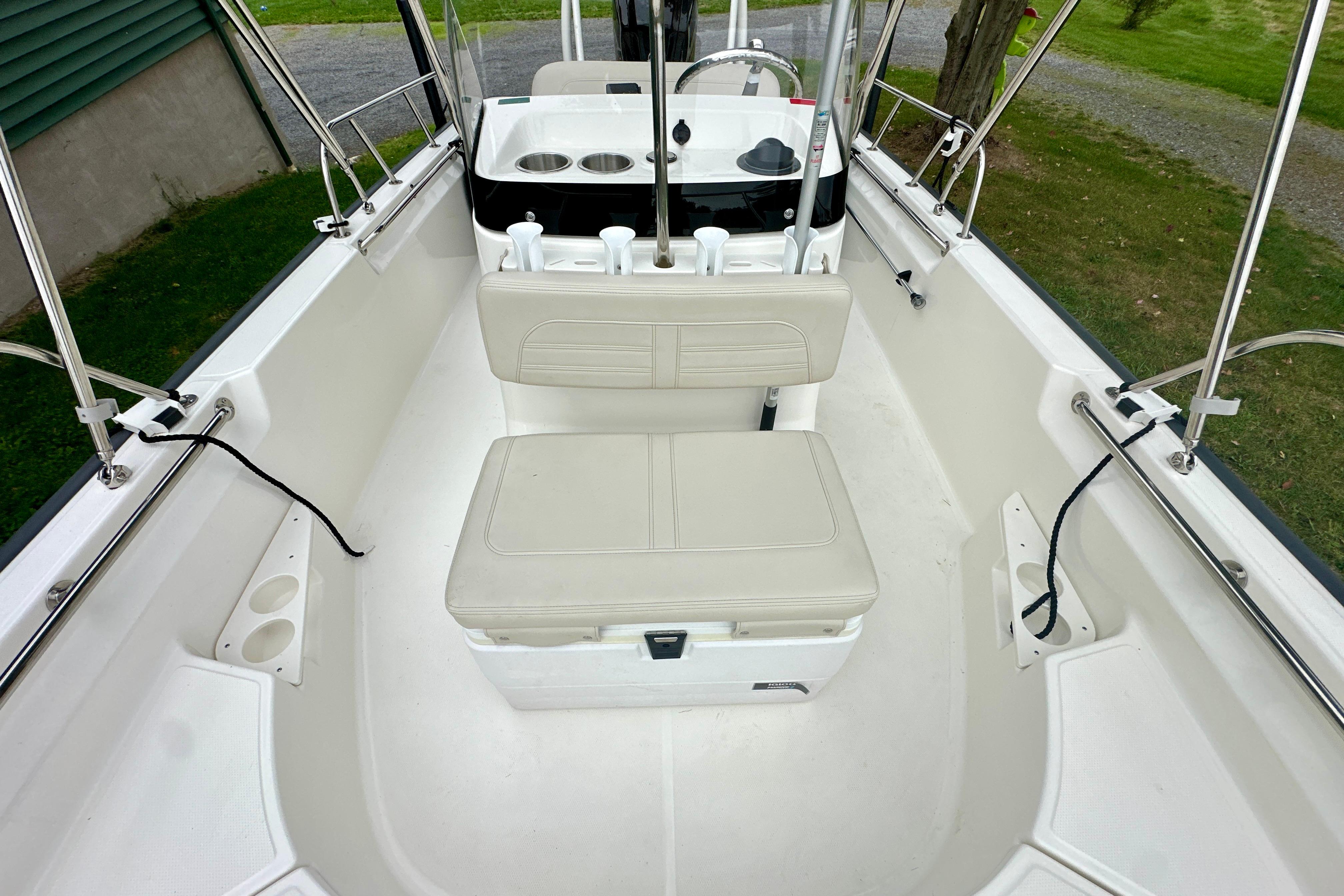 2024 Boston Whaler 170 Montauk interior with seating and console, showcasing spacious design.