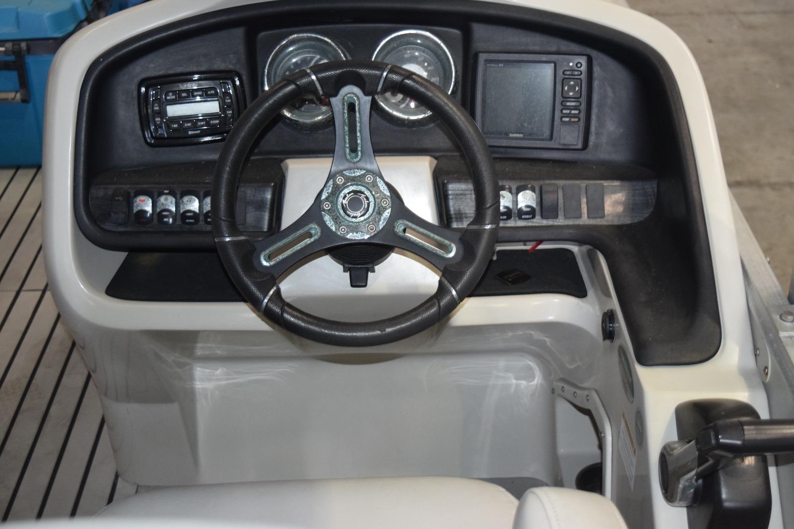 Steering console of 2018 Avalon Catalina Cruise Funship boat with controls and gauges.