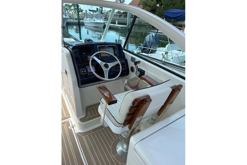 2013 Pursuit DC 265 Dual Console boat cockpit with steering wheel and controls.