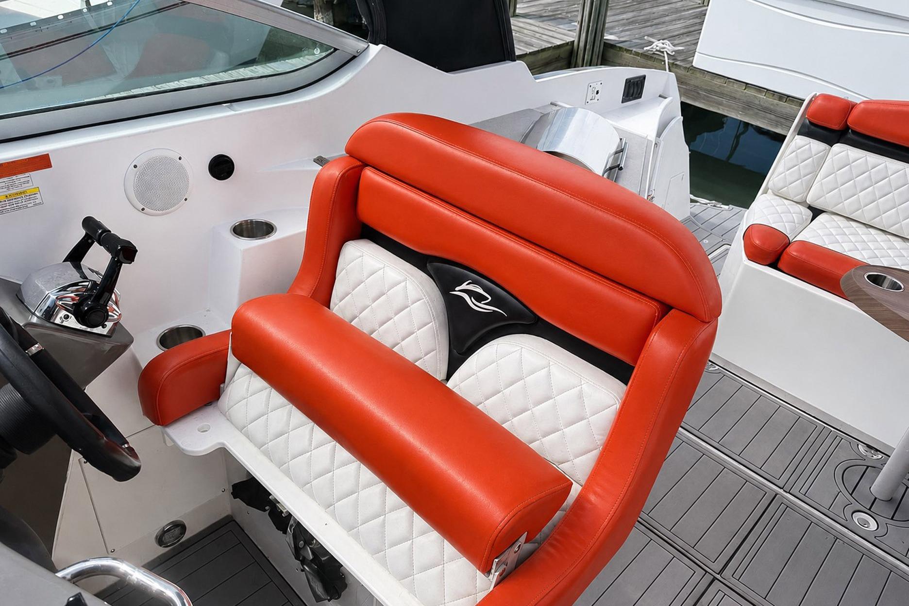 2012 Rinker 310 Express Cruiser LE interior with red and white seating, modern design.