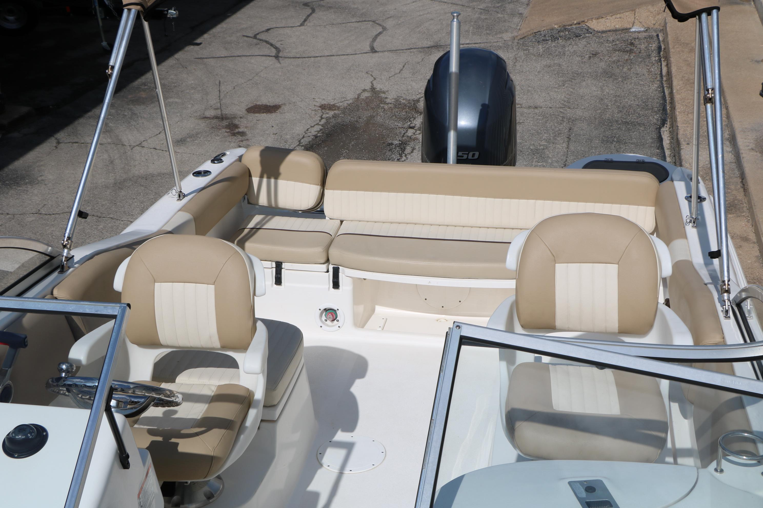 2017 Sea Fox 226 Traveler boat interior with beige seating and steering console.