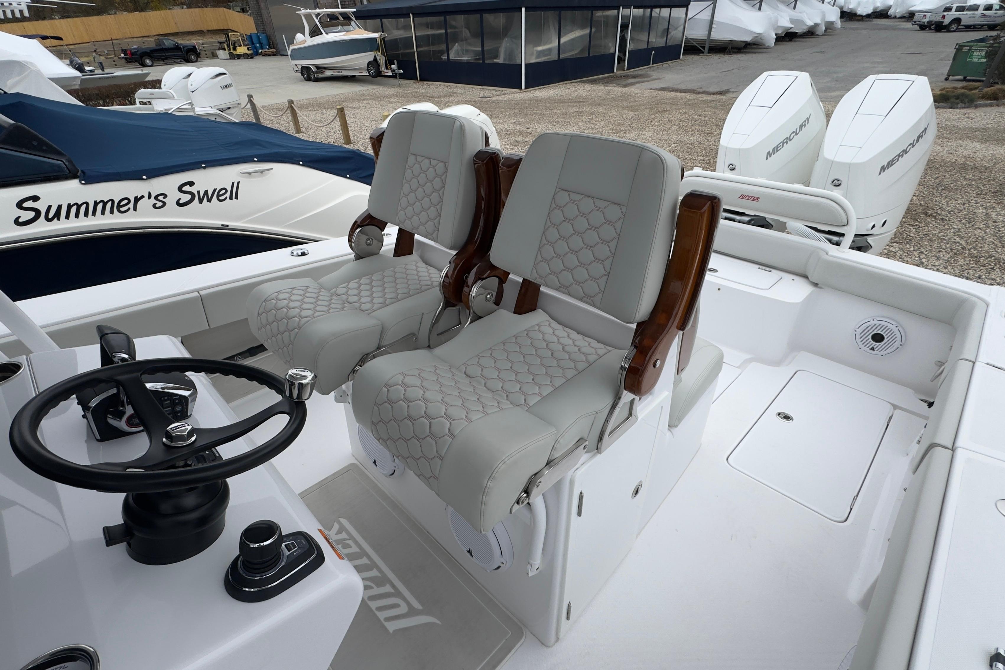 2024 Jupiter 32 FS boat interior with dual seats and steering wheel.