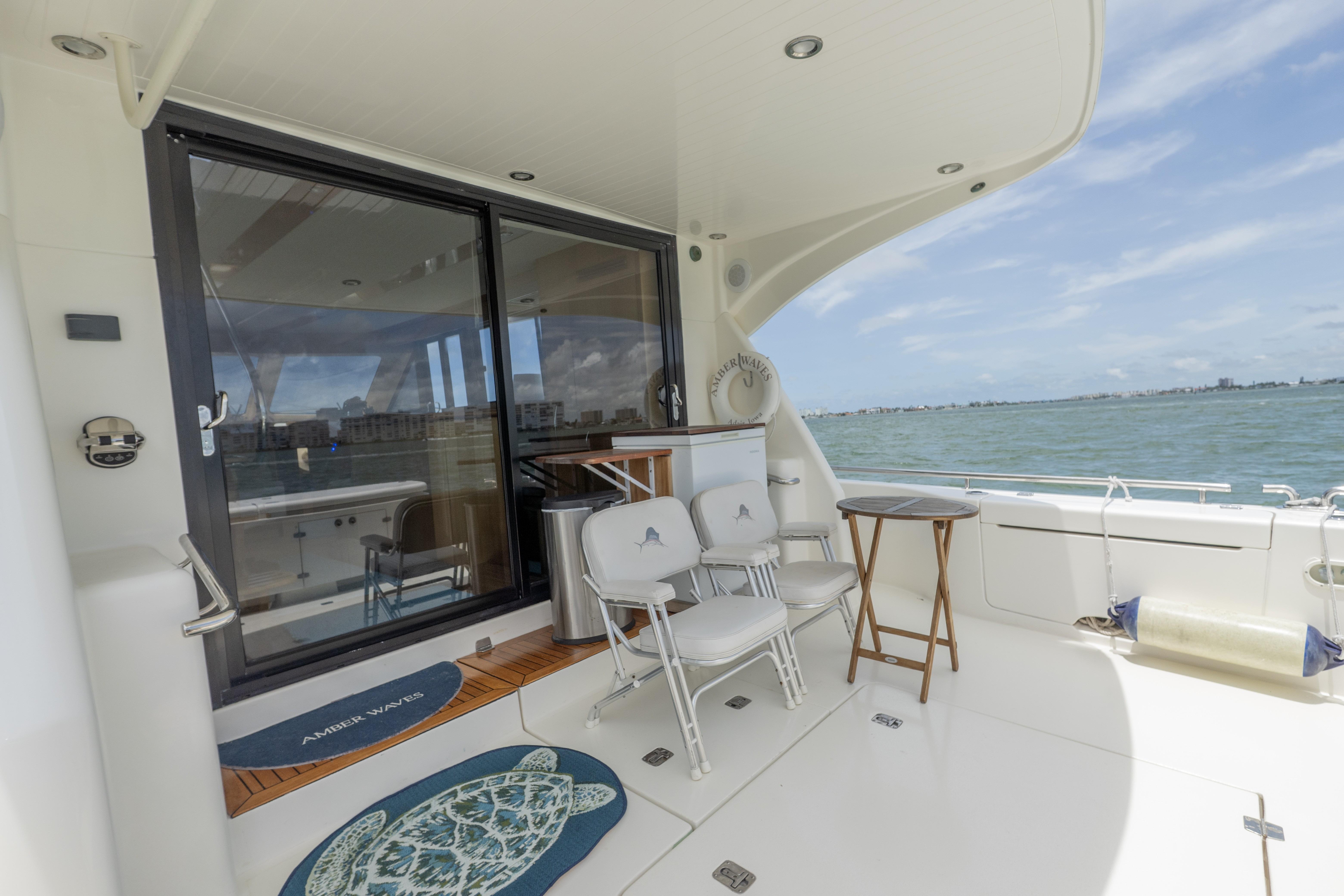 2008 Maritimo 52 yacht deck with chairs, table, and ocean view.