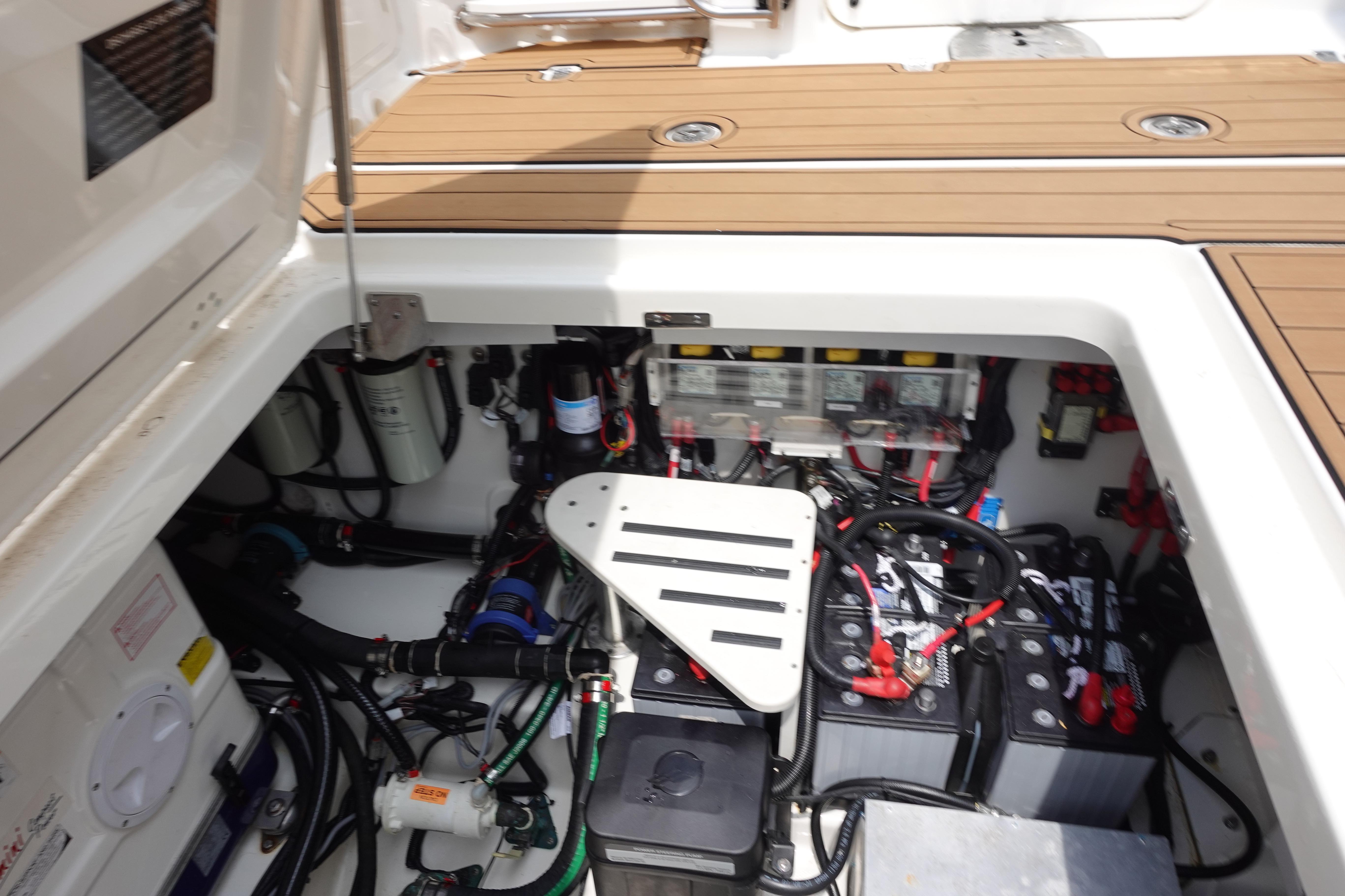Engine compartment of a 2020 Boston Whaler 420 Outrage, showcasing batteries and wiring.