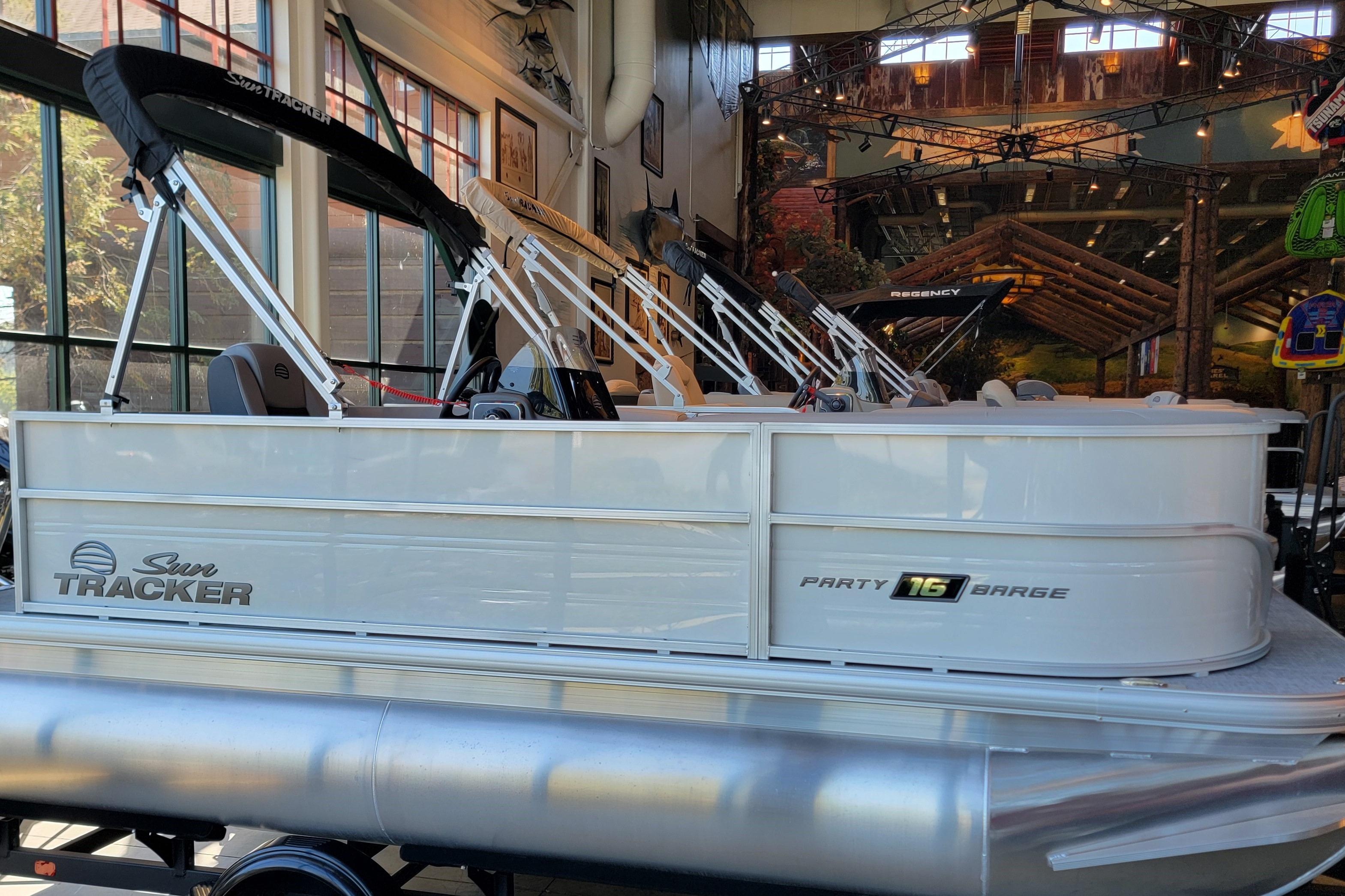2026 Sun Tracker Party Barge 16 DLX pontoon boat displayed indoors.