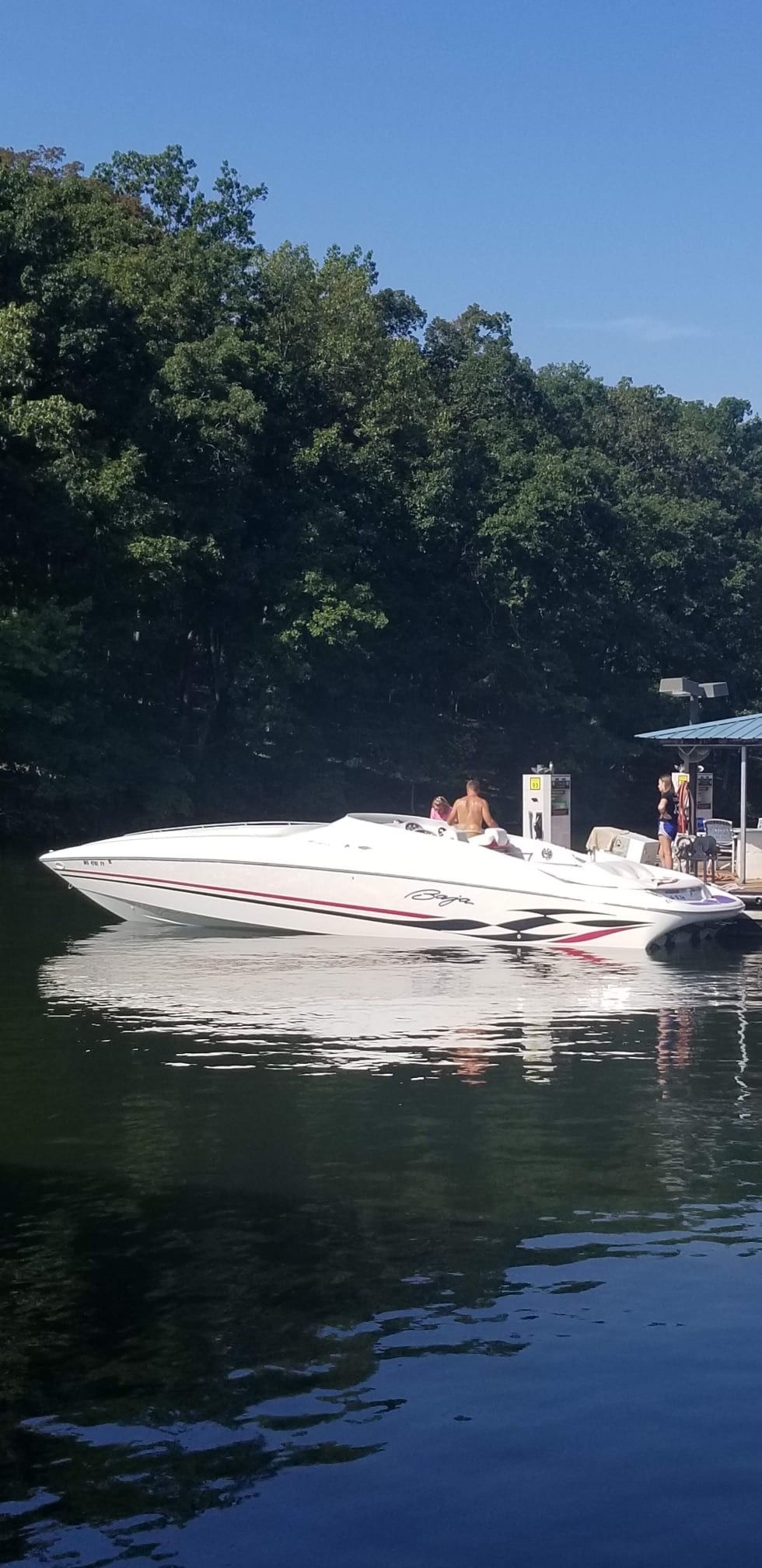 1997 Baja 38 Special Boss boat at lakeside dock.