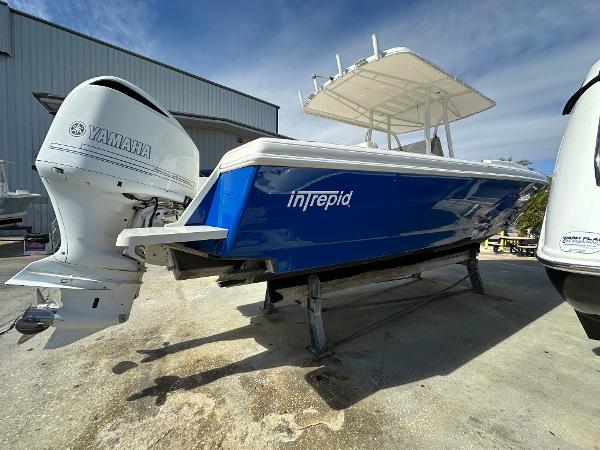 Blue 2005 Intrepid 323 boat with Yamaha outboard motor on a trailer.