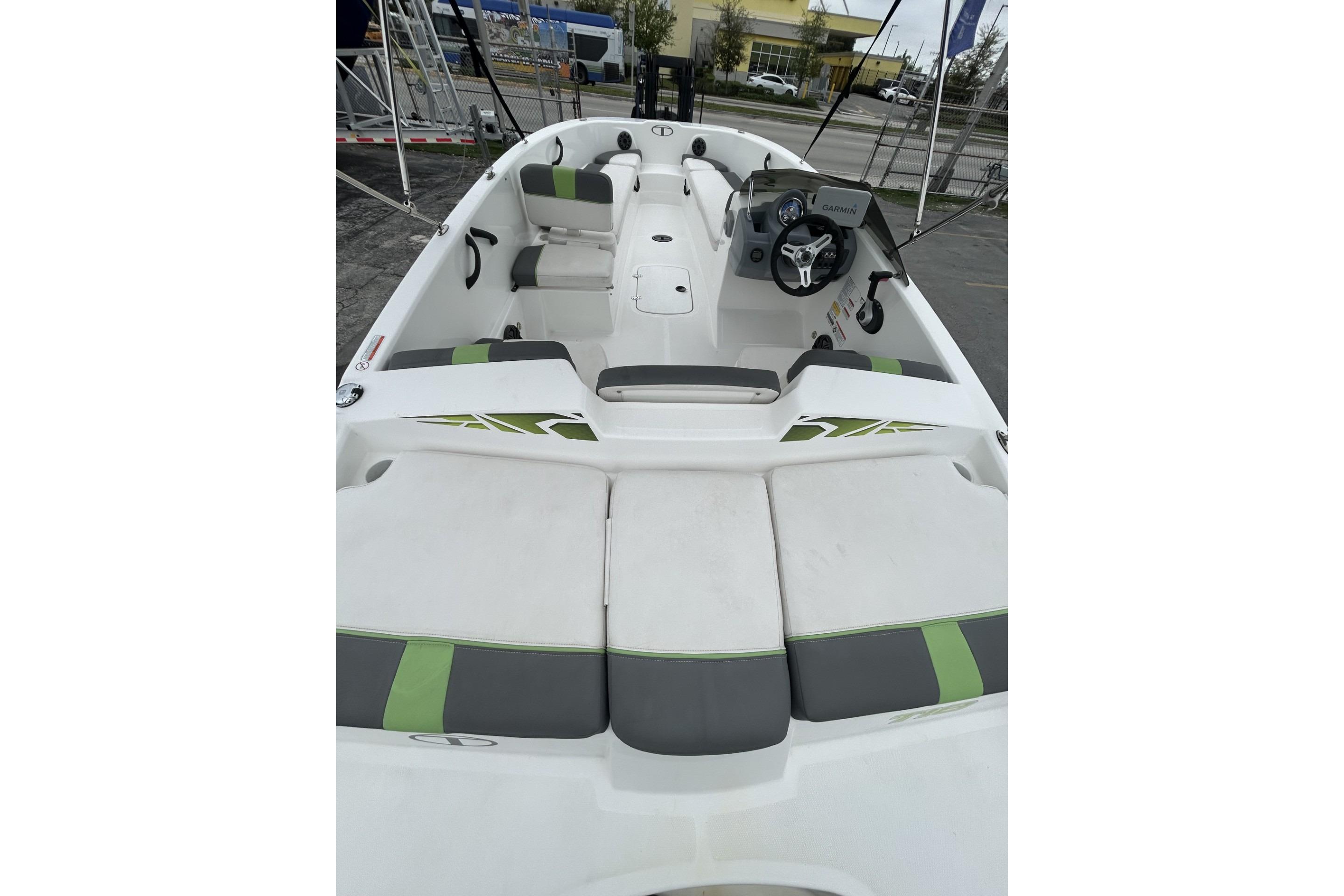 2022 Tahoe T18 boat interior with seating and steering wheel, featuring green and gray accents.