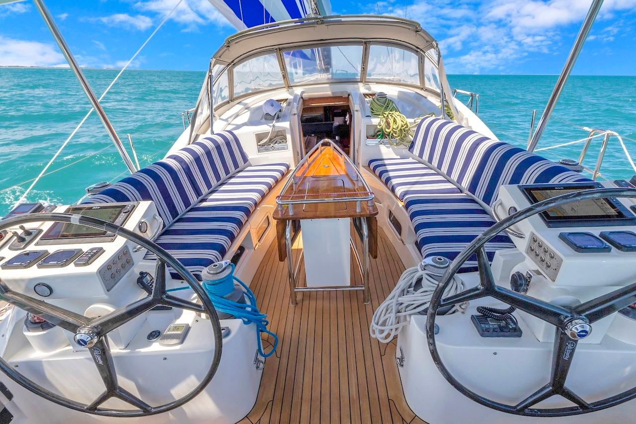 Cockpit of 2011 Southerly 57 RS yacht with striped seating and dual steering wheels.