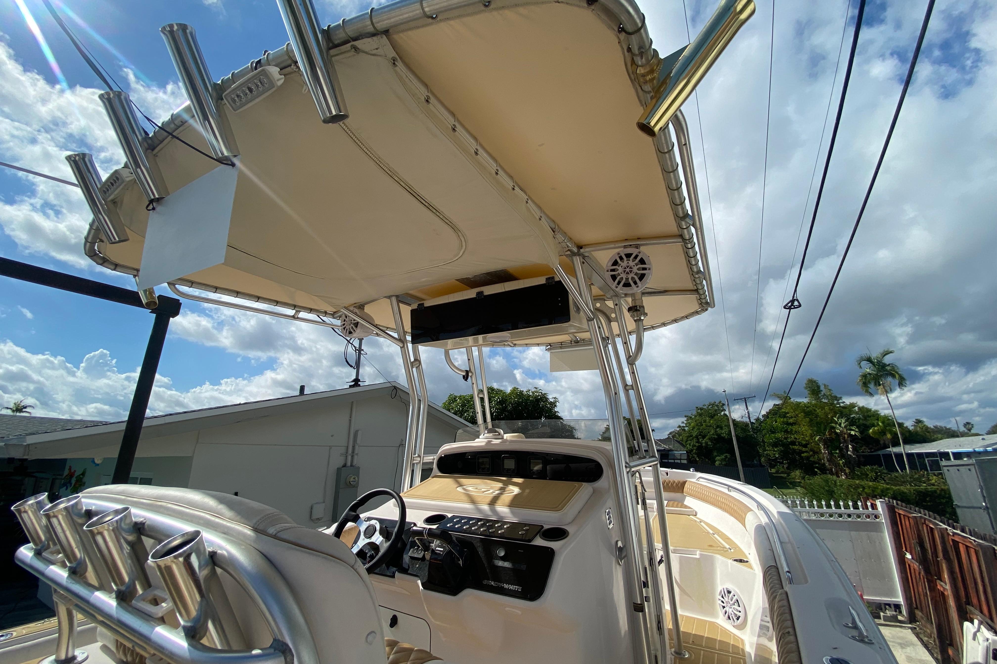 2004 Grady-White Canyon 283 boat with T-top and rod holders under a cloudy sky.