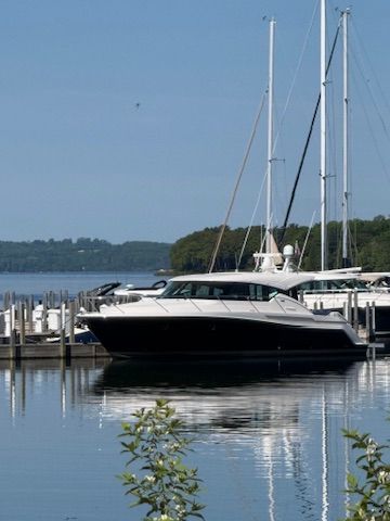 A 2017 Tiara Yachts C44 Coupe docked at a serene marina.
