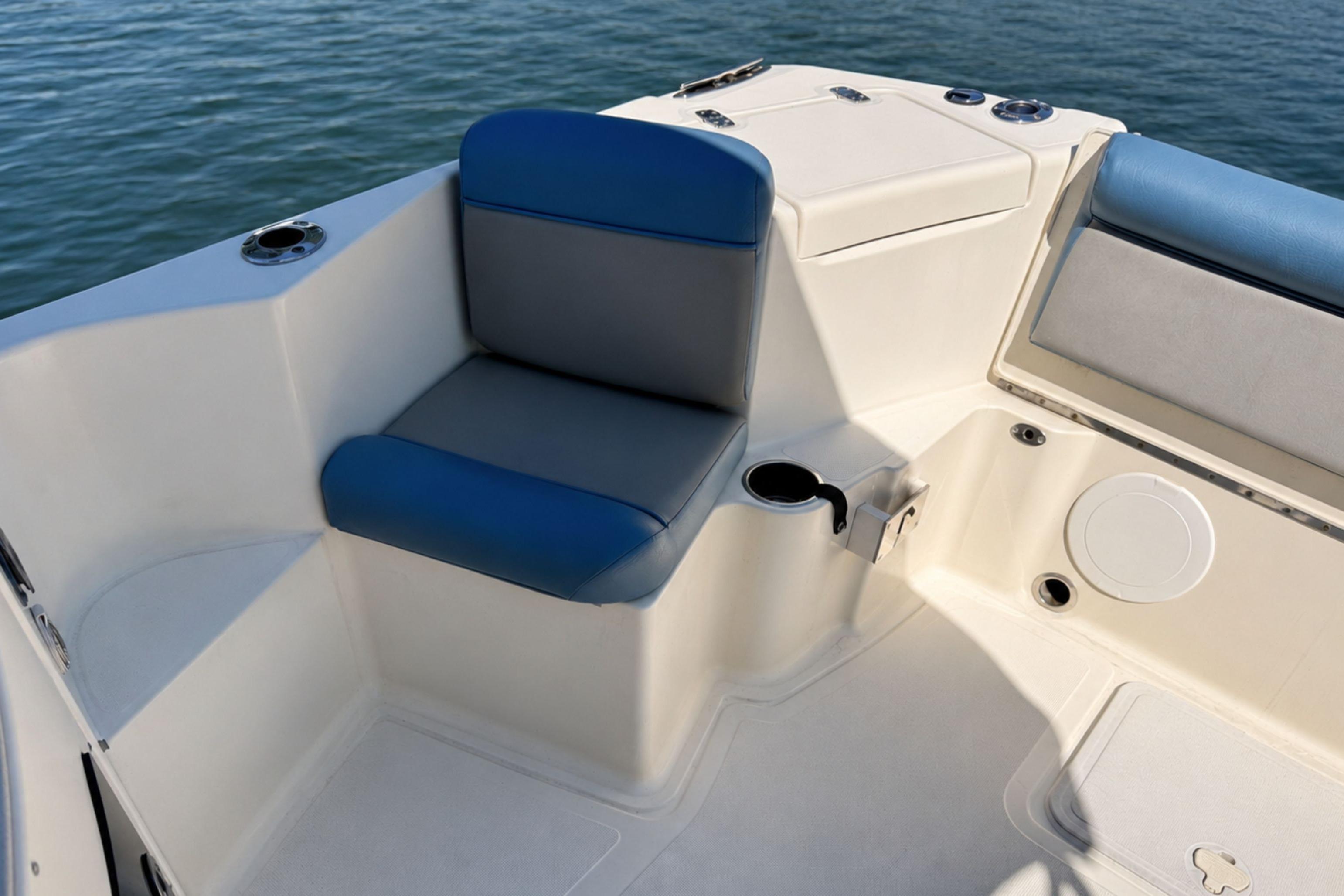 Interior seating of 2008 Scout 222 Abaco boat with blue and gray cushions.