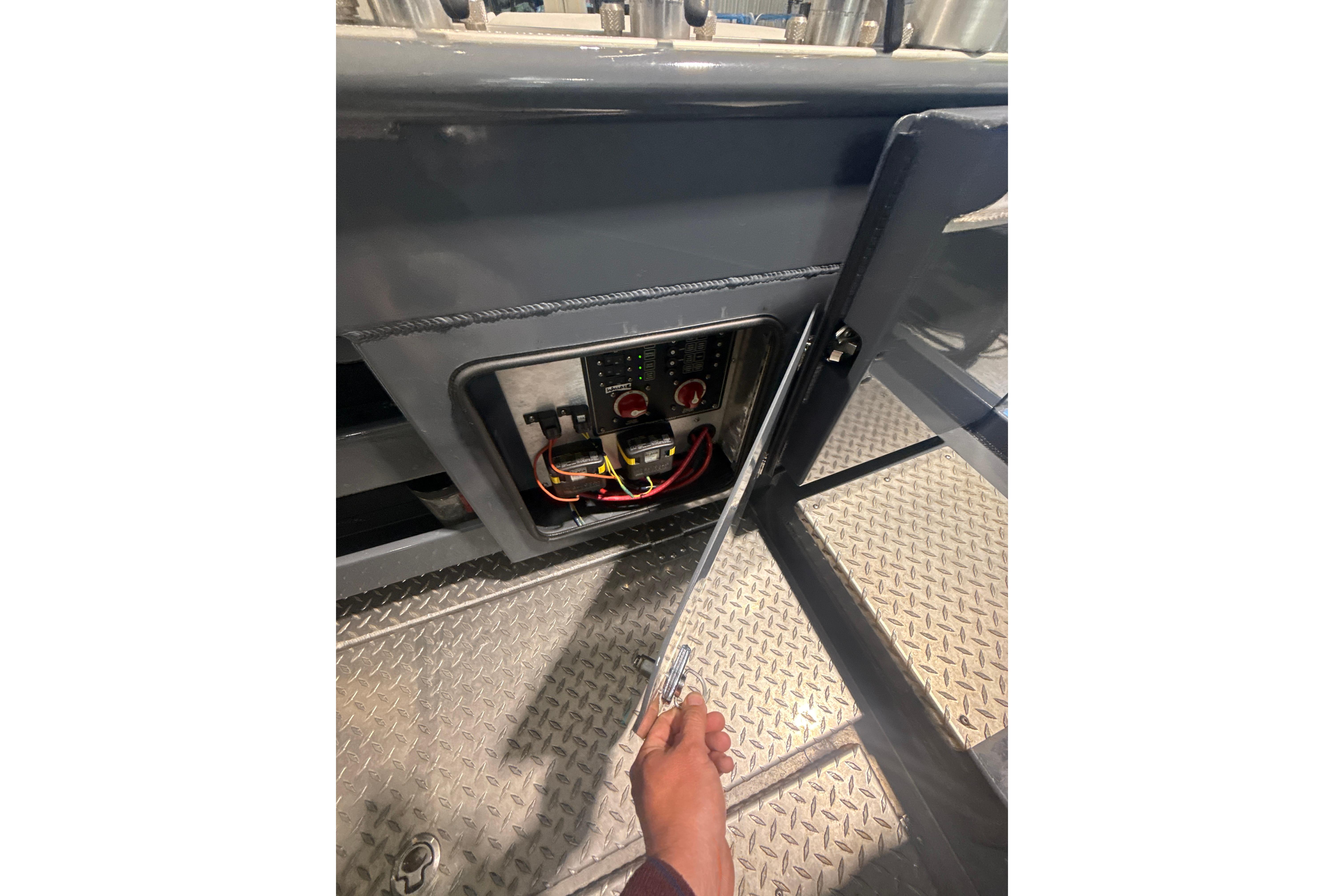 2022 Hewescraft 270 Alaskan Hardtop electrical panel with open access door.