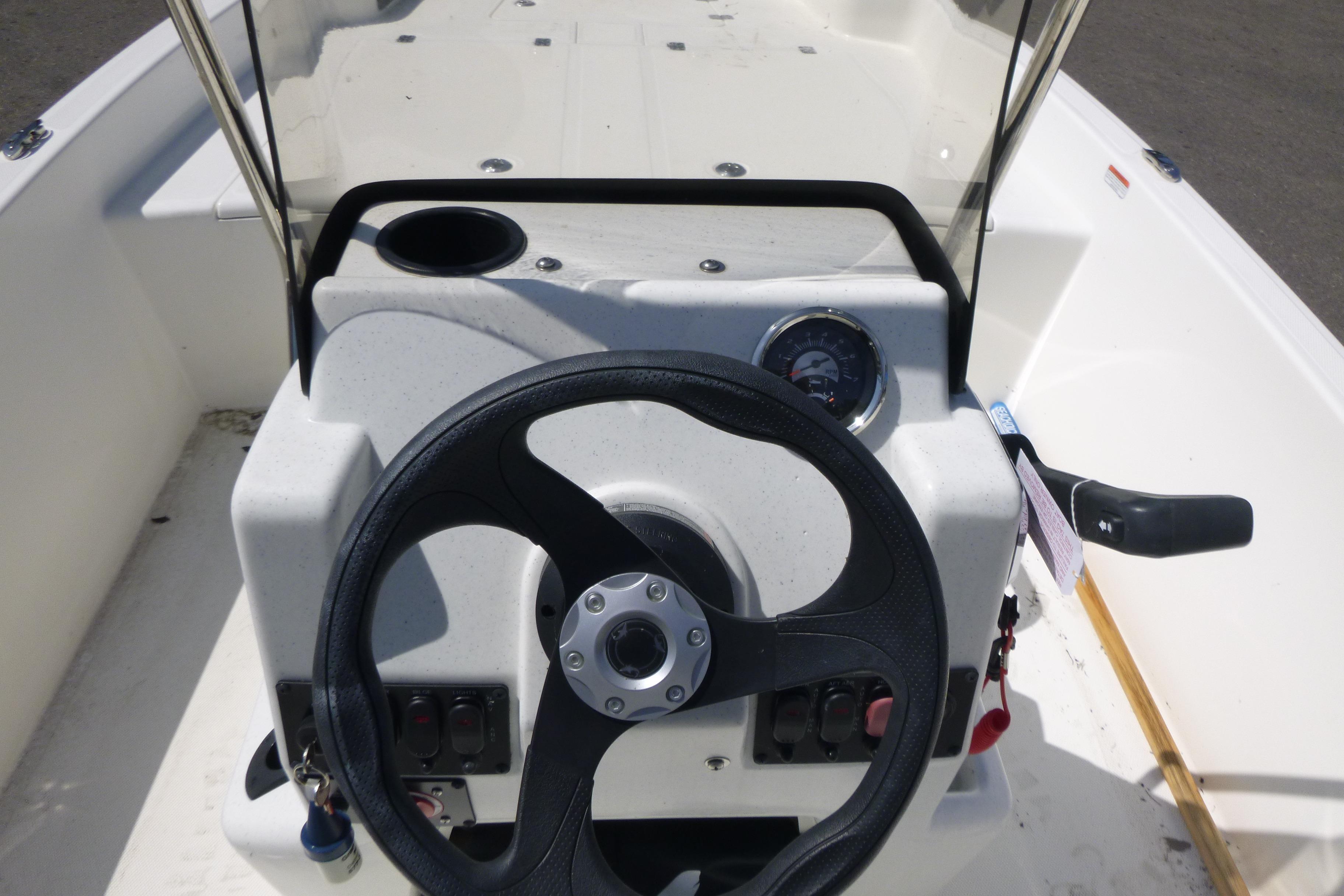 2024 Mako Pro Skiff 17 CC boat console with steering wheel and controls.