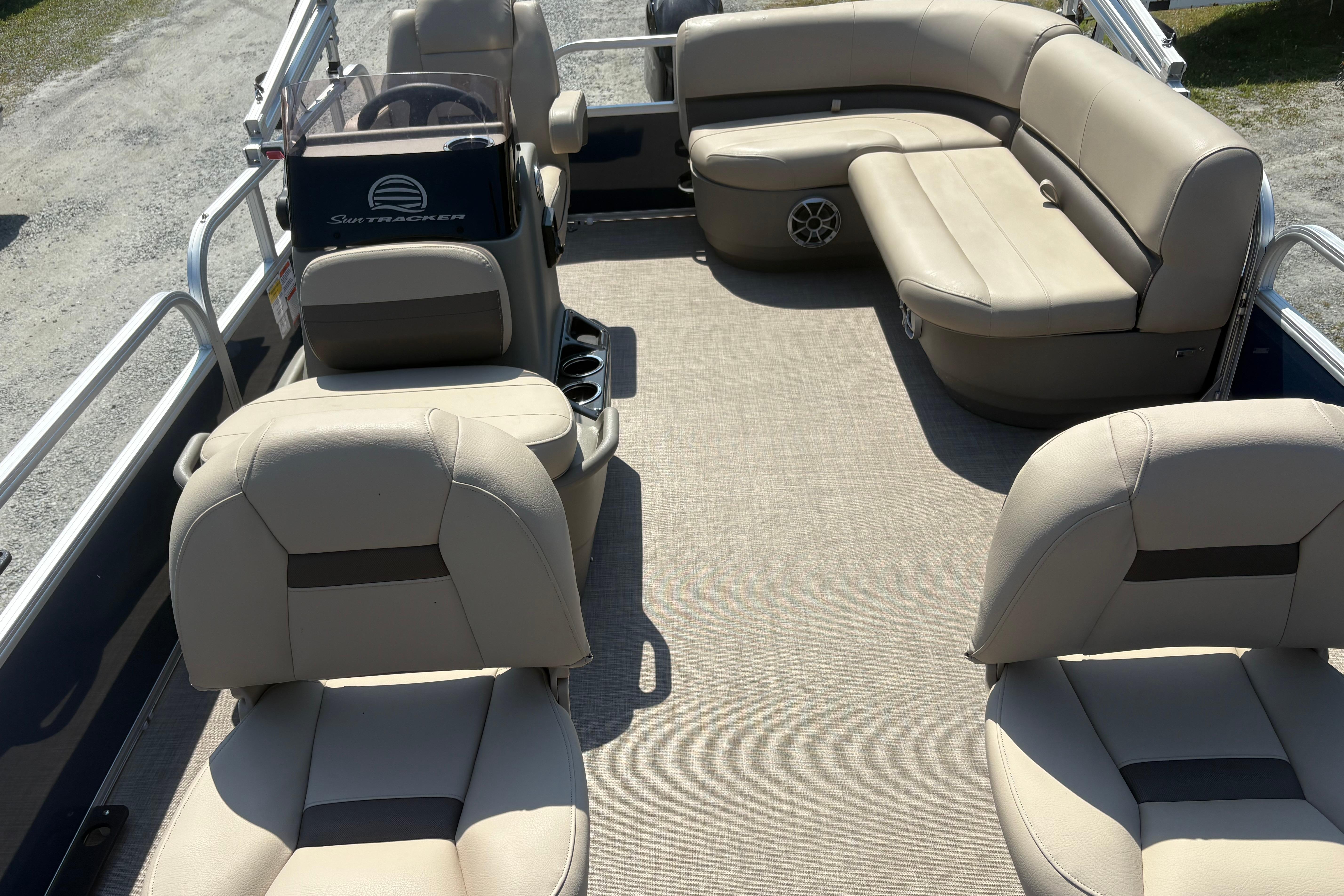 2024 Sun Tracker Bass Buggy 16 DLX pontoon boat interior with beige seating.