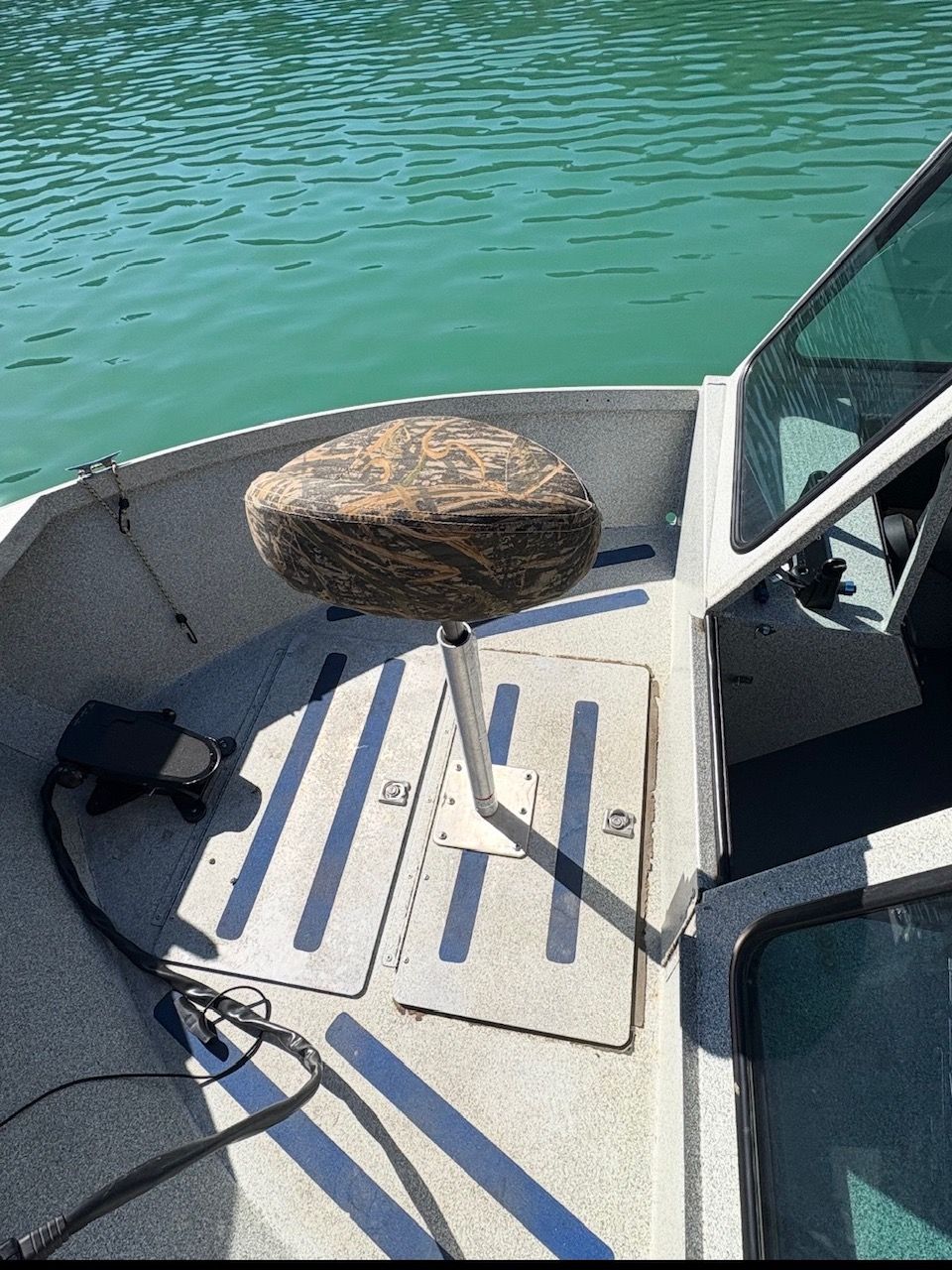 A 2002 Stryker Rogue boat with an elevated seat on the deck.