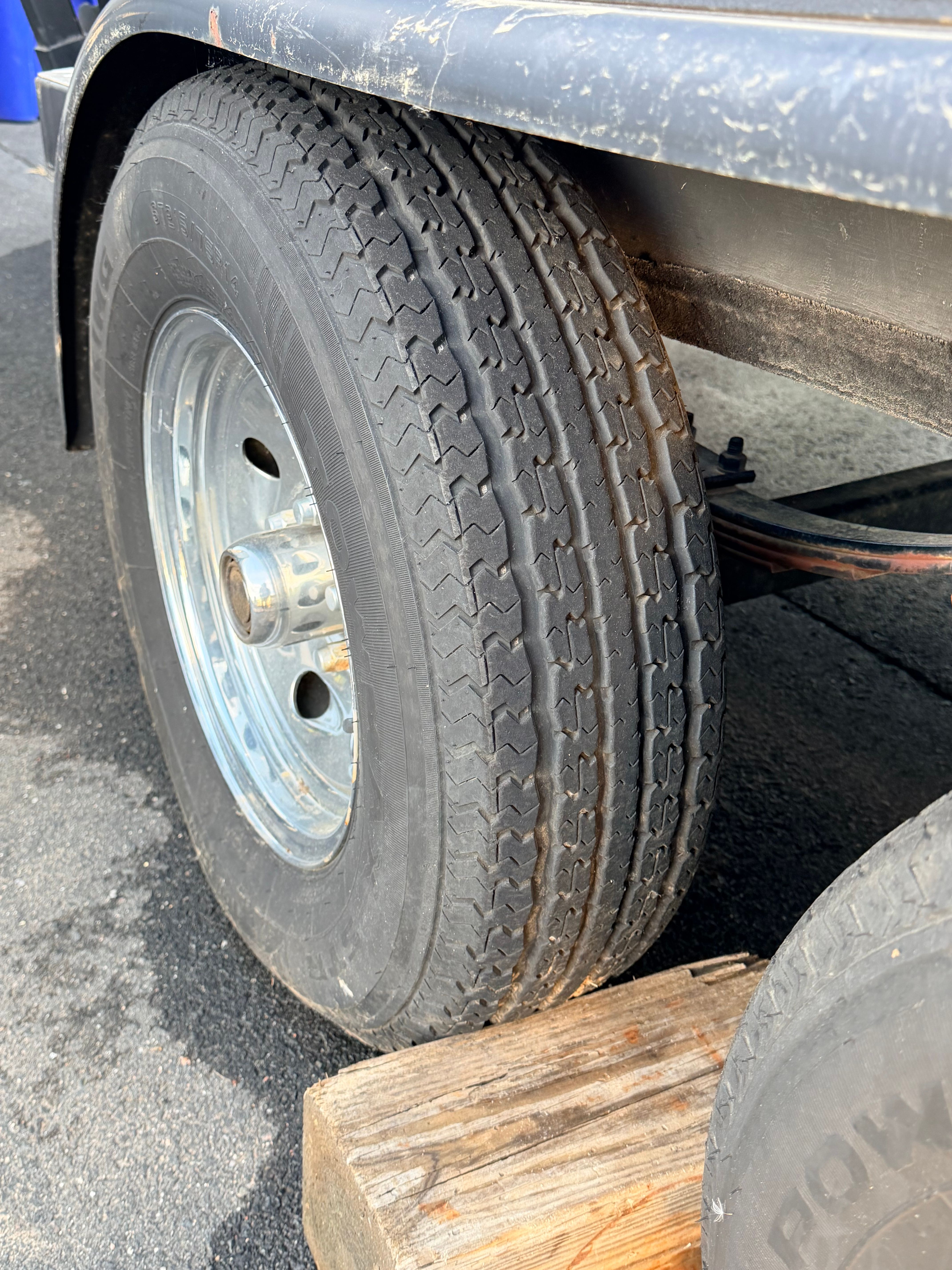 Close-up of a 2006 Malibu iRide tire on a wooden block.