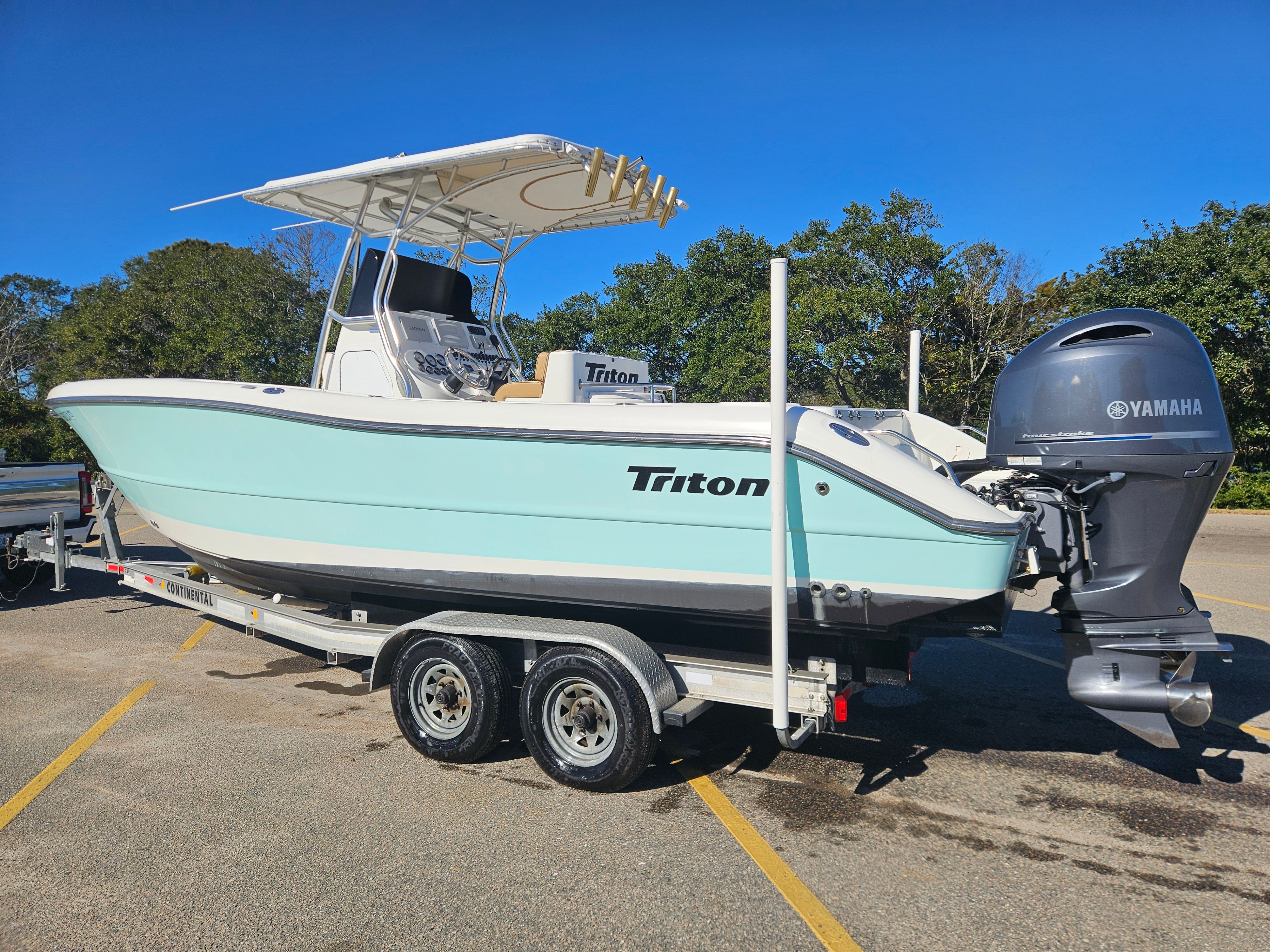 2004 Triton 2690 CC boat on trailer parked outdoors.