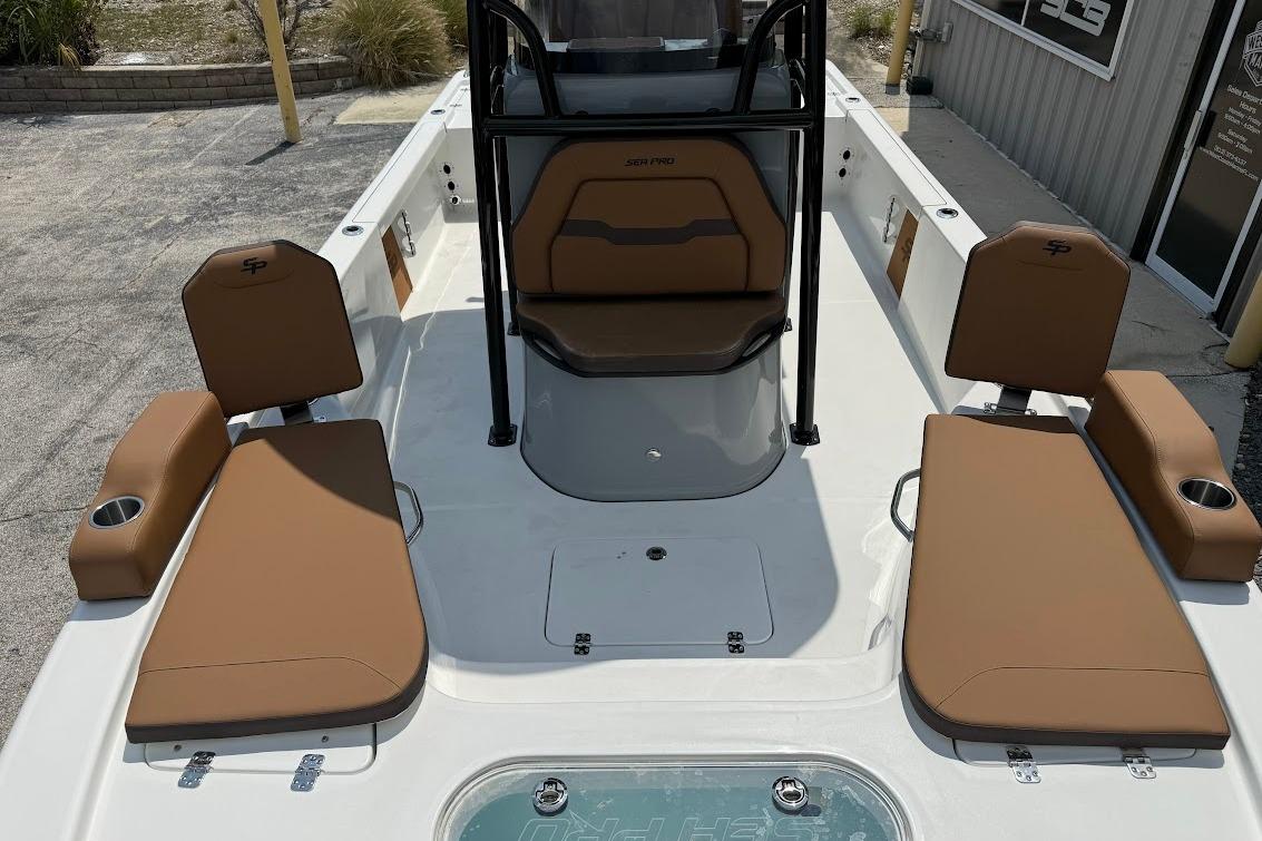 2026 Sea Pro 250 Bay boat interior with tan seating and cup holders.