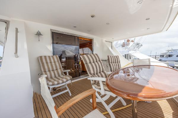 Grand Harbour 76 yacht deck, 2001 model, with striped chairs and round table.