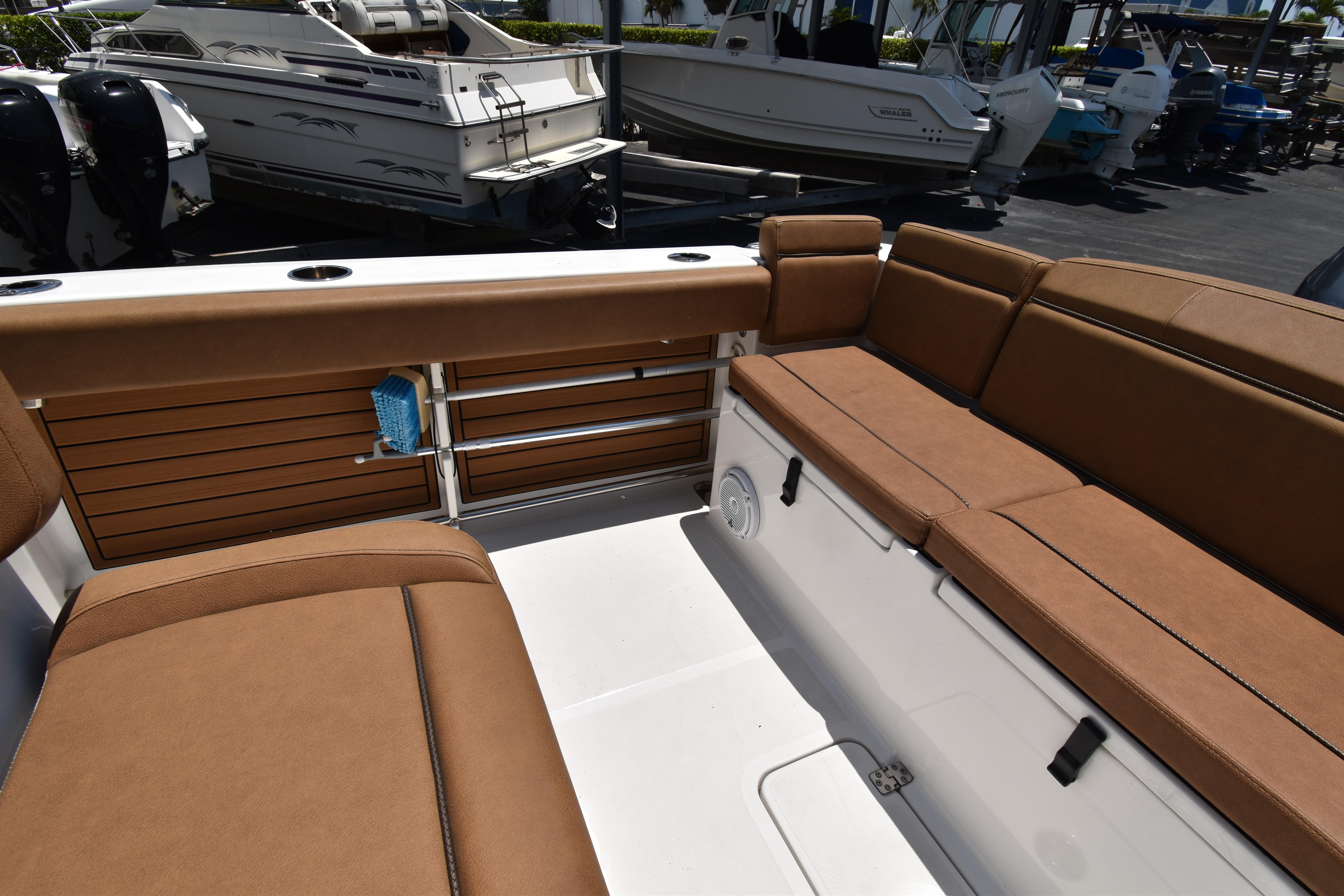 2020 Sea Hunt Ultra 275 SE boat interior with brown seating and storage compartments.