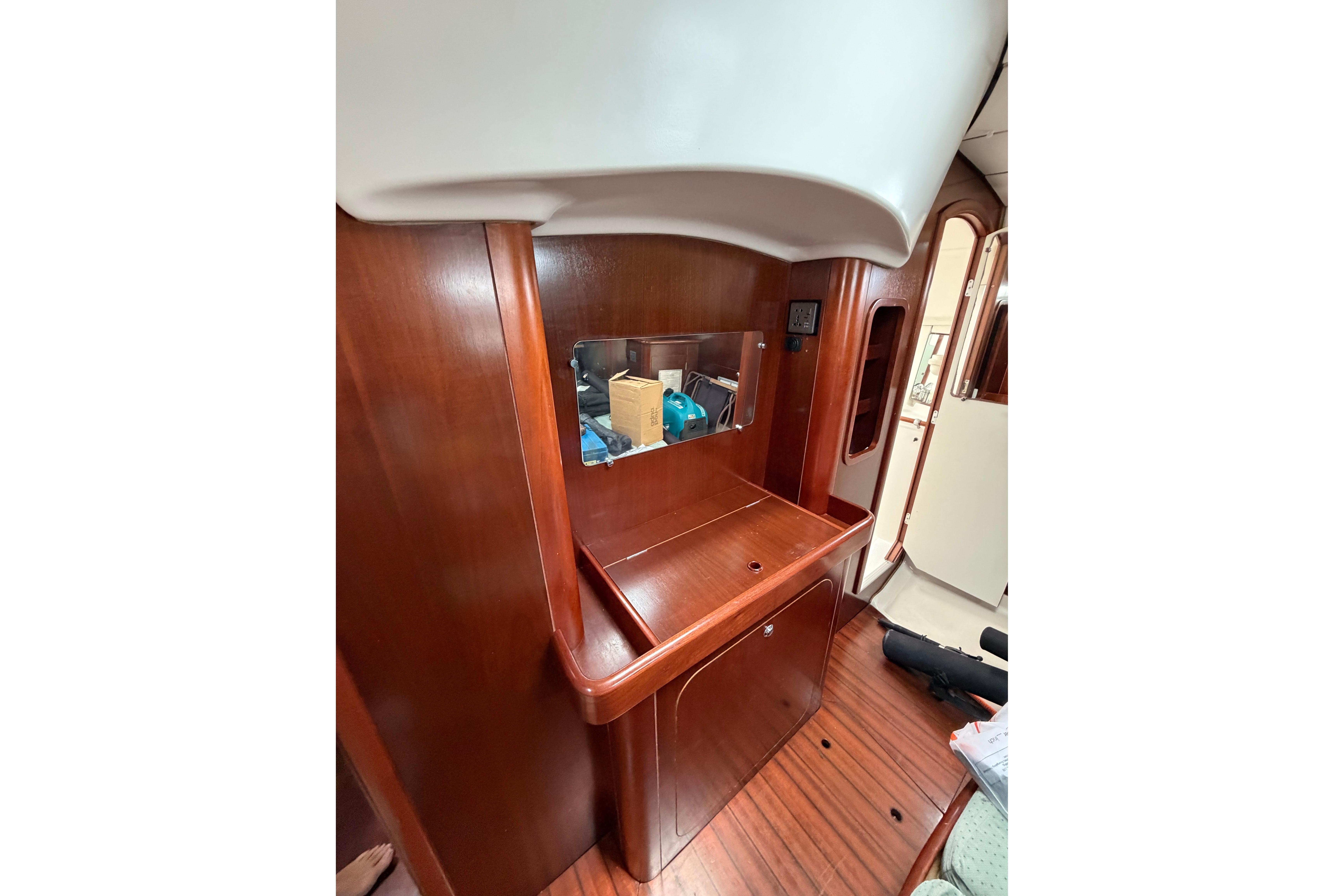 1998 Beneteau Oceanis Clipper 40 CC interior with wooden cabinetry and mirror.