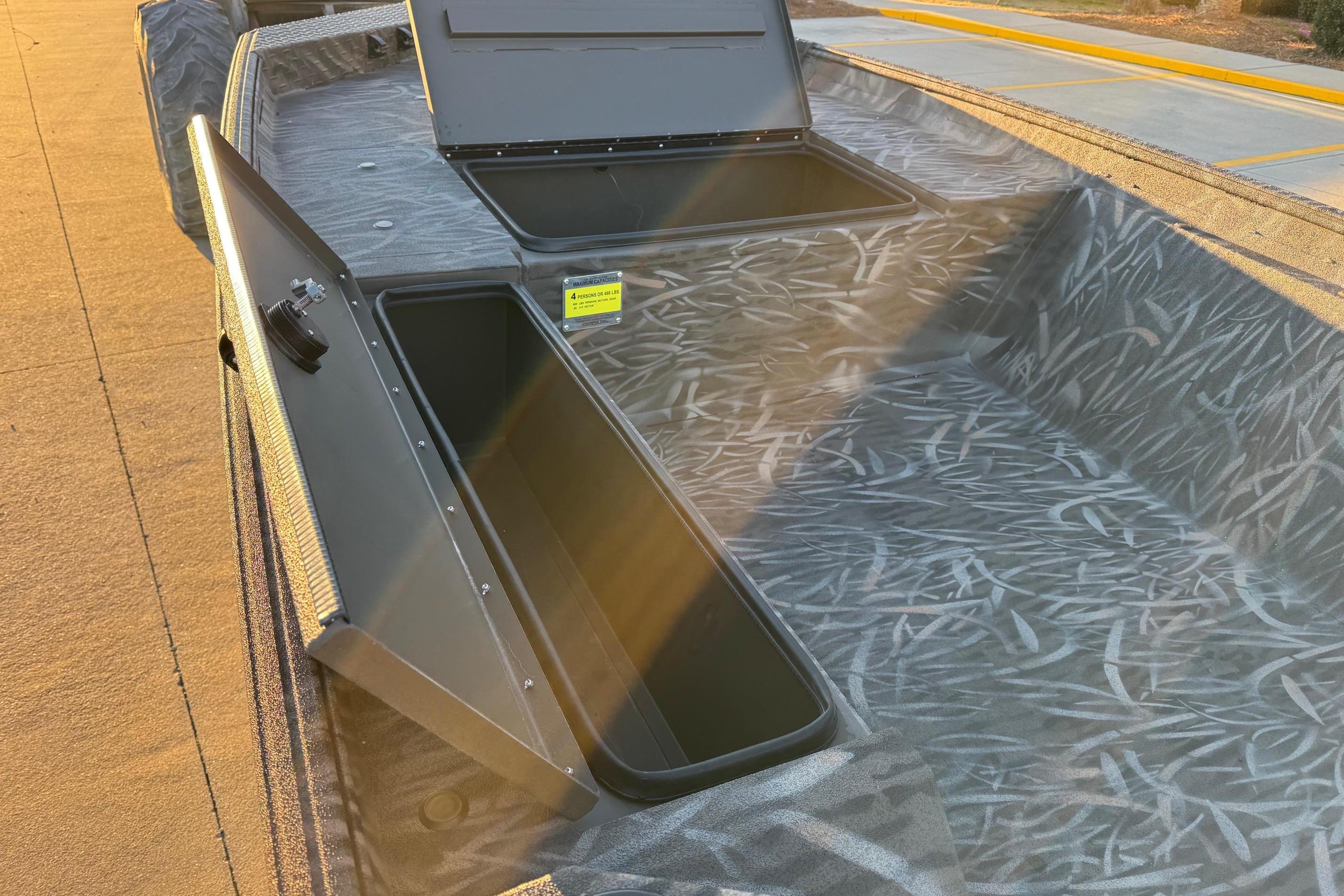 2026 Alweld 1652 Invader boat with open storage compartments, showcasing interior design.