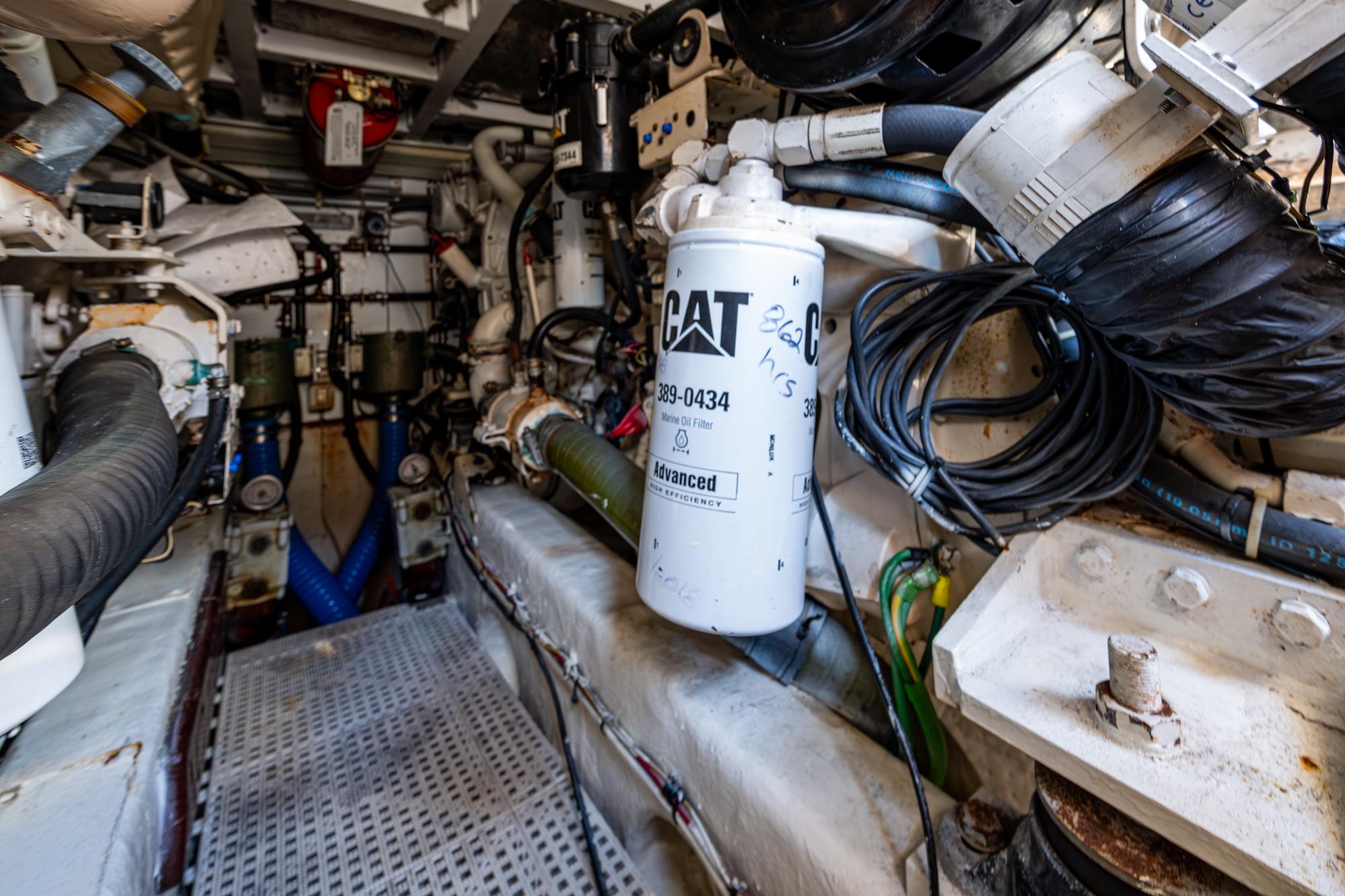 Engine room of a 2000 Fairline Squadron 52 yacht, featuring mechanical components and wiring.