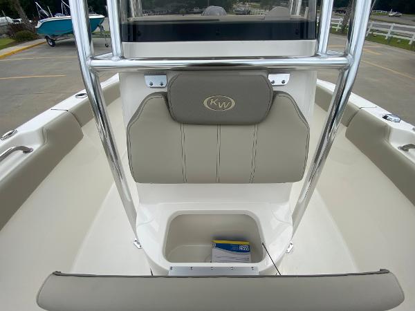 2024 Key West 203 FS boat interior with storage compartment and cushioned seating.