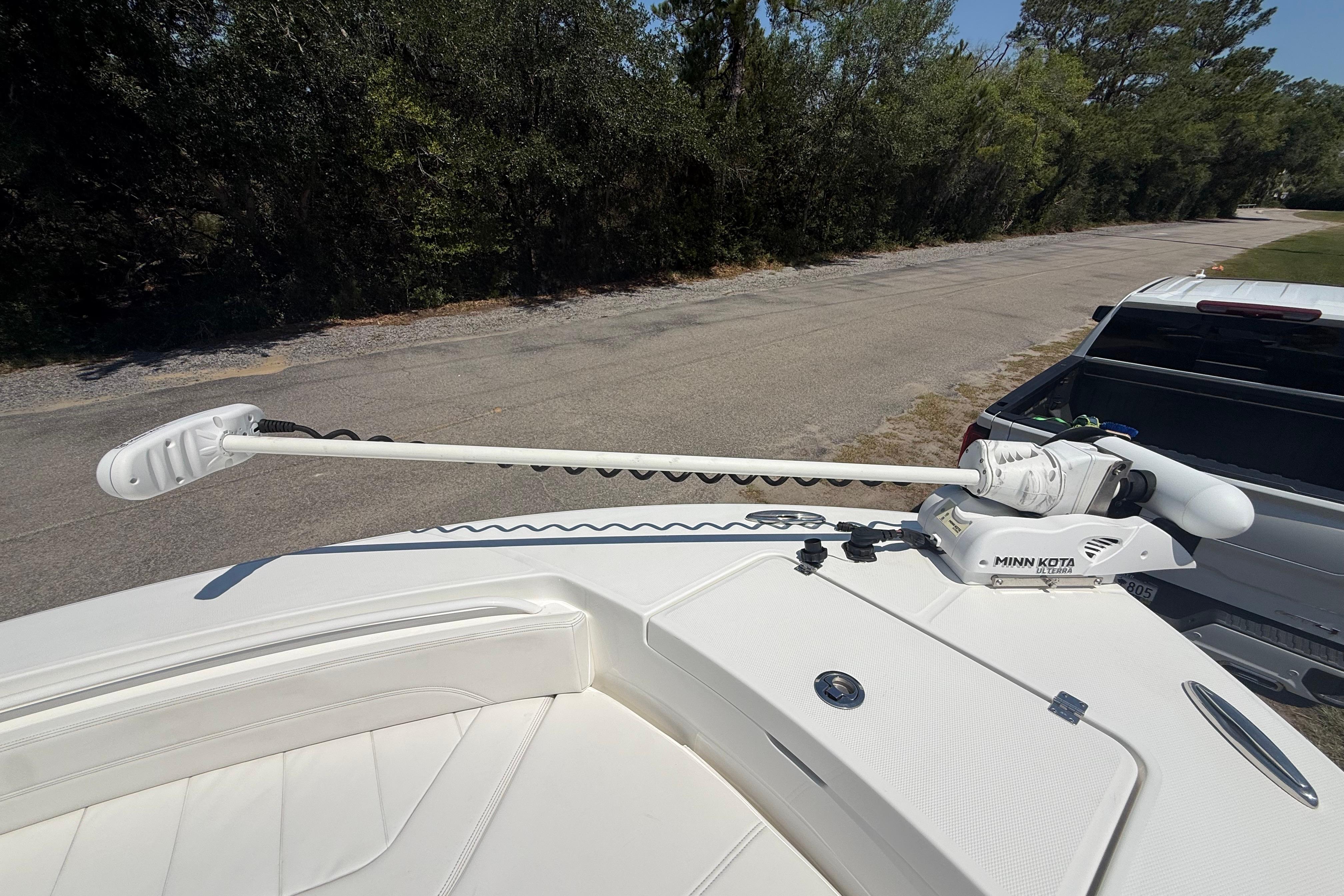 2023 Regulator 26XO boat with Minn Kota trolling motor on deck.