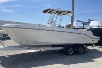 2023 Trophy T24 CC boat on trailer, parked outdoors under clear sky.