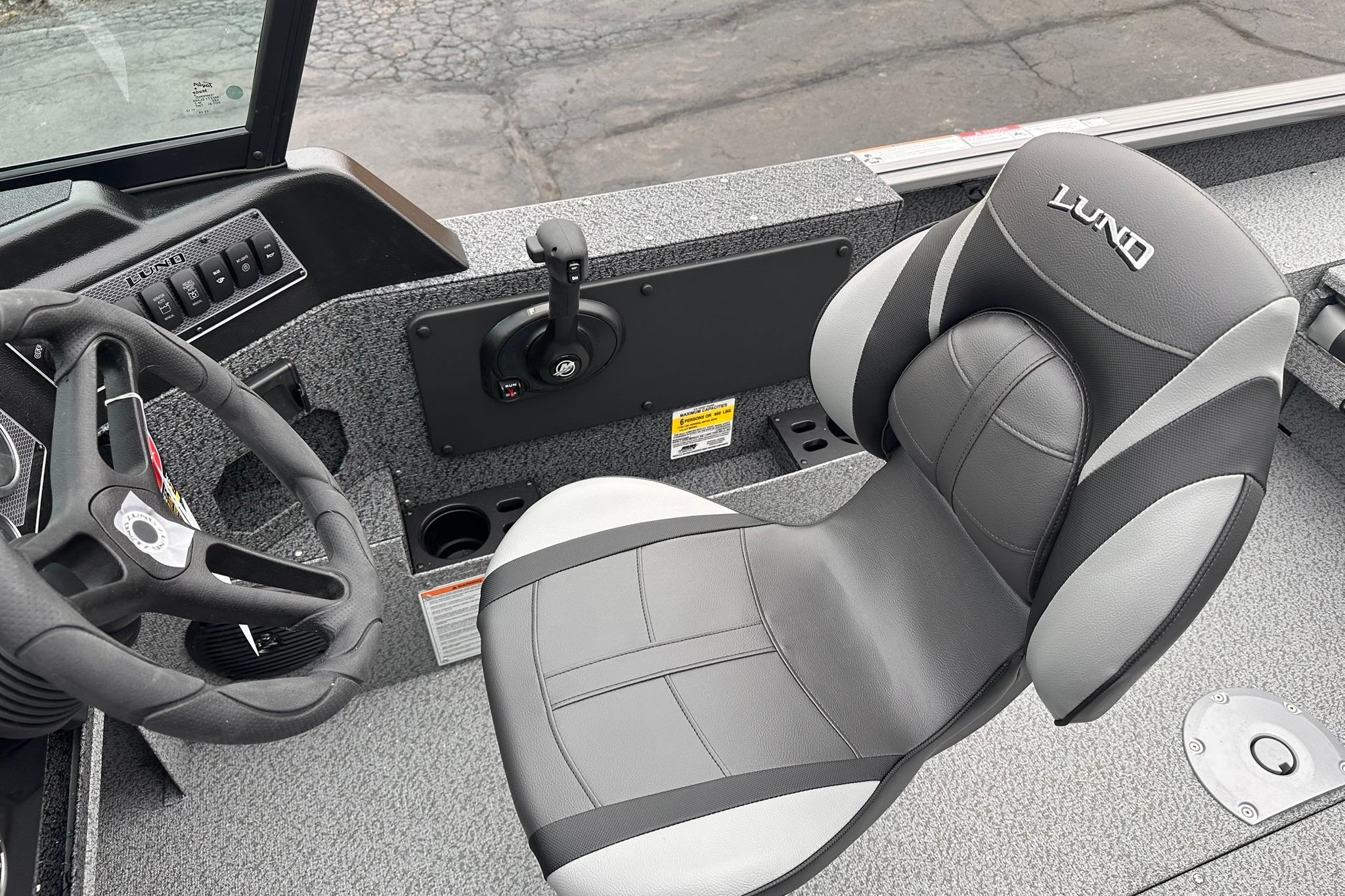 2026 Lund 1775 Impact XS Sport boat interior with steering wheel and seat.