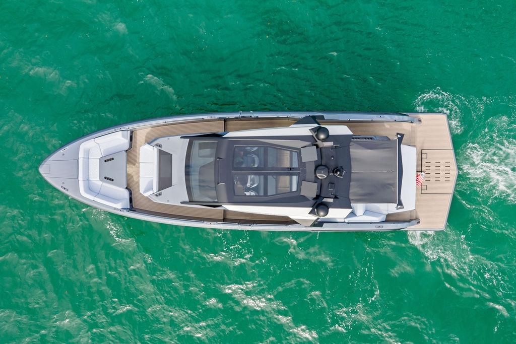 Aerial view of 2024 Vanquish Yachts VQ55 cruising on turquoise water.