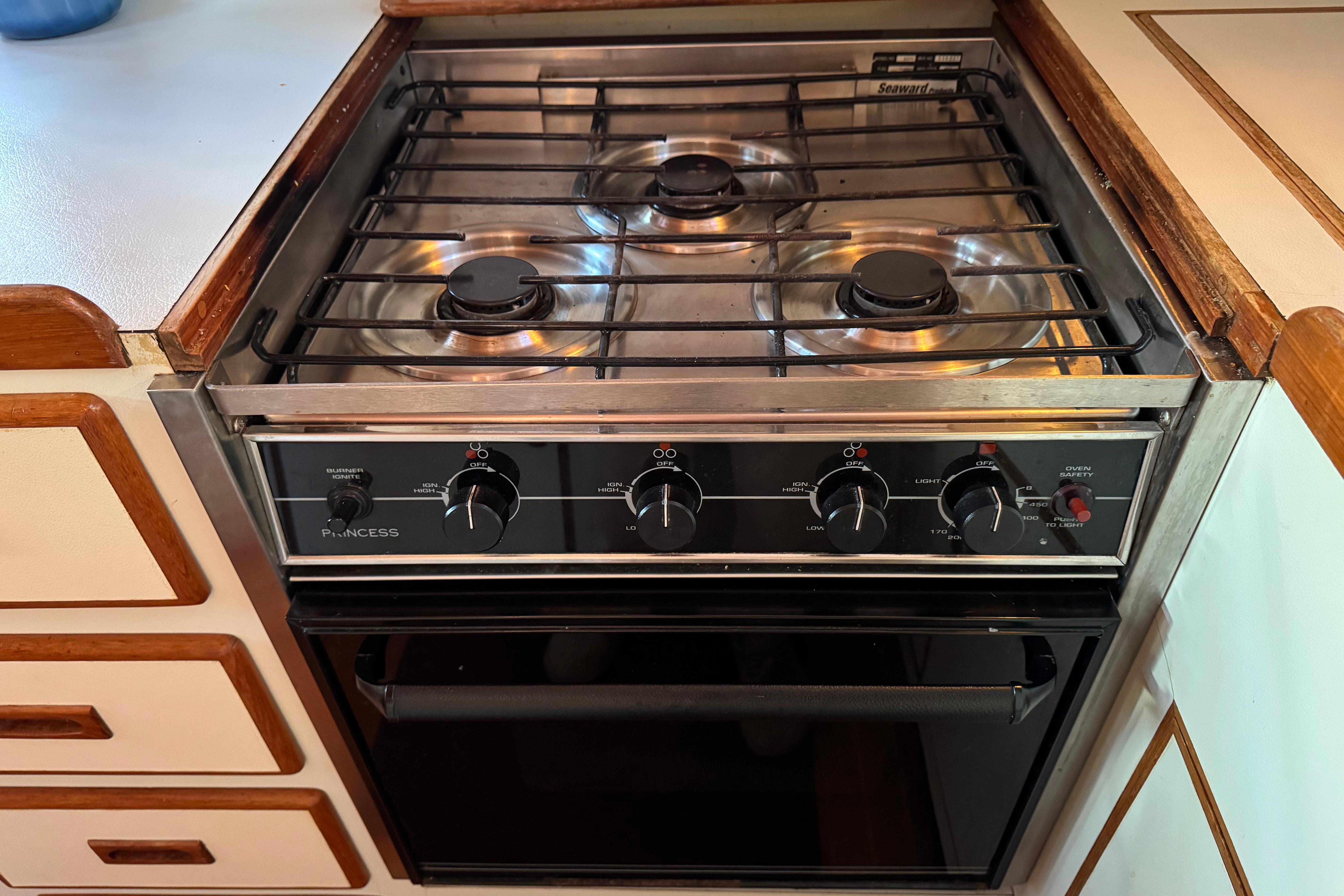 Vintage 1987 President 37 stove with three burners and oven in a wooden kitchen setting.