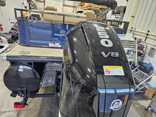 2024 Regency 250 DL3 boat with powerful V8 outboard motor in a workshop.
