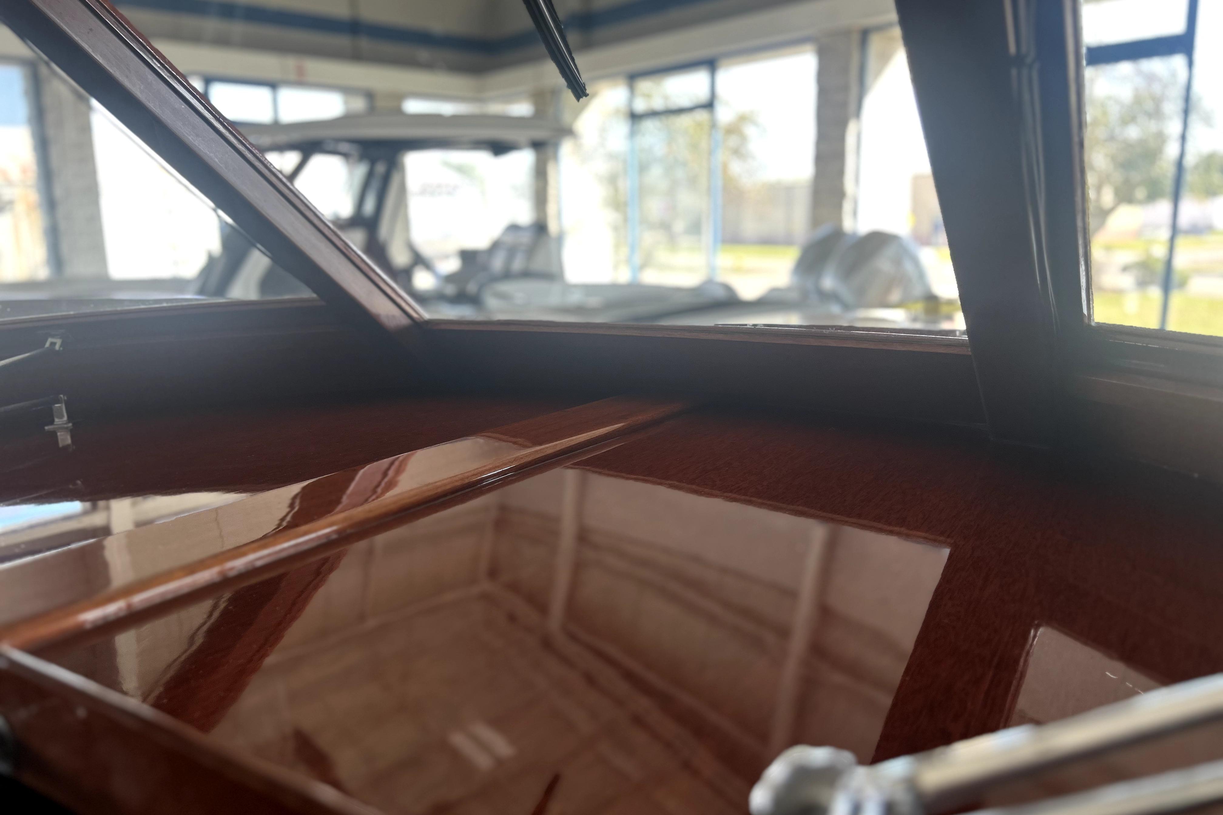1962 Prowler Forest Johnson boat interior with polished wood finish in a showroom.
