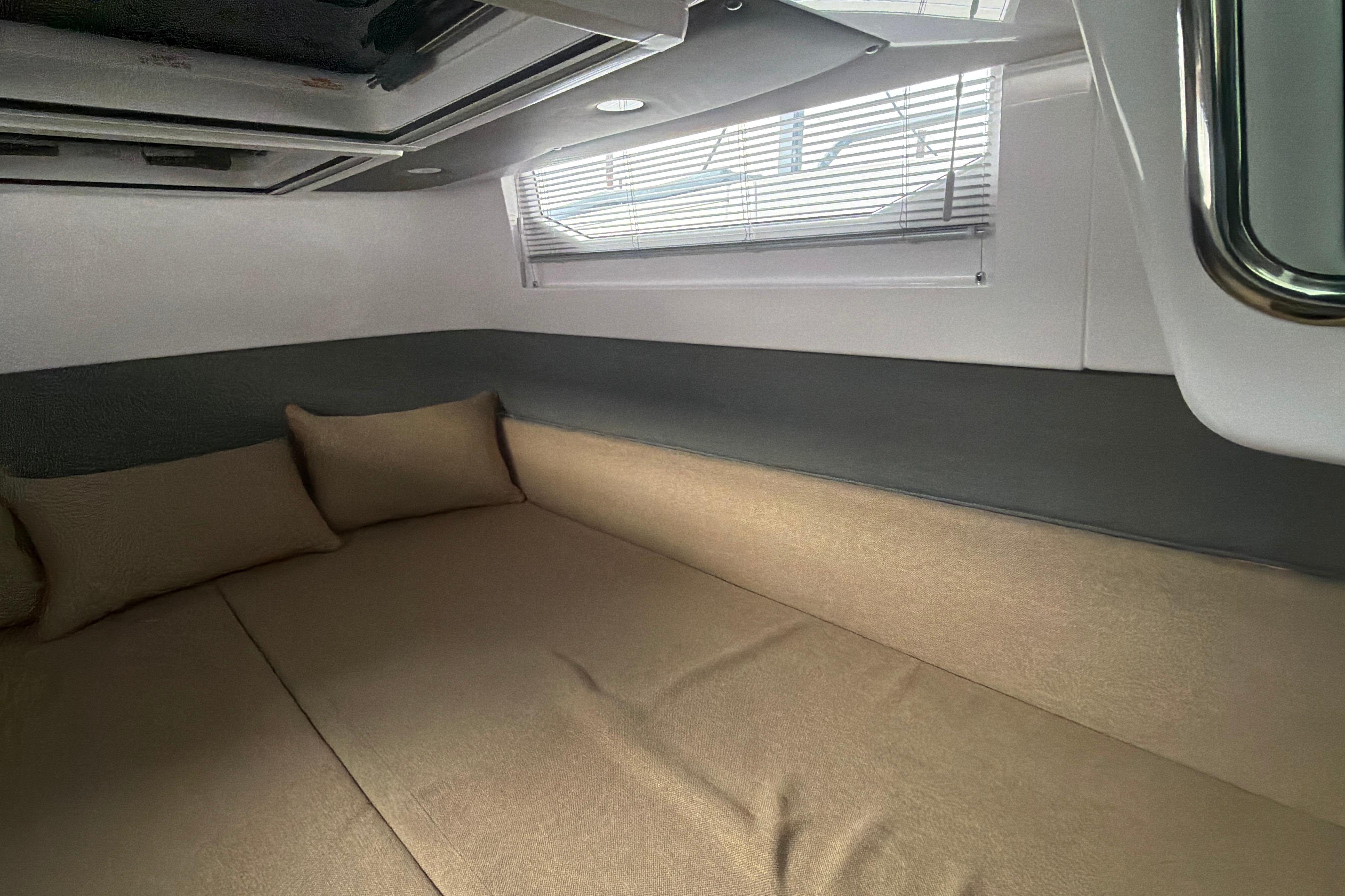 Interior cabin of 2022 Axopar Brabus 37 XC Cross Cabin with beige cushions.