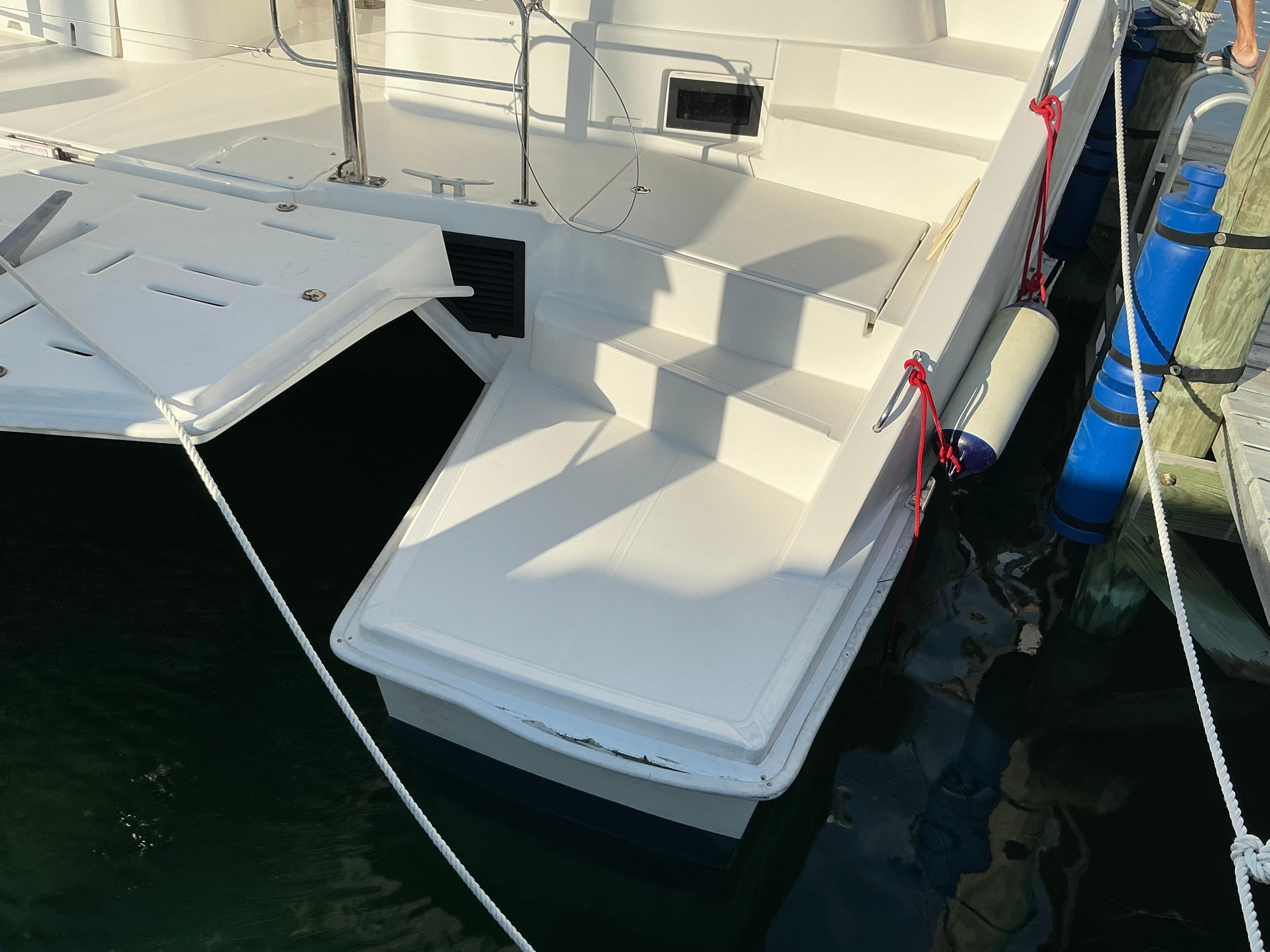 2019 Leopard 51 Powercat yacht stern with steps and docked at marina.