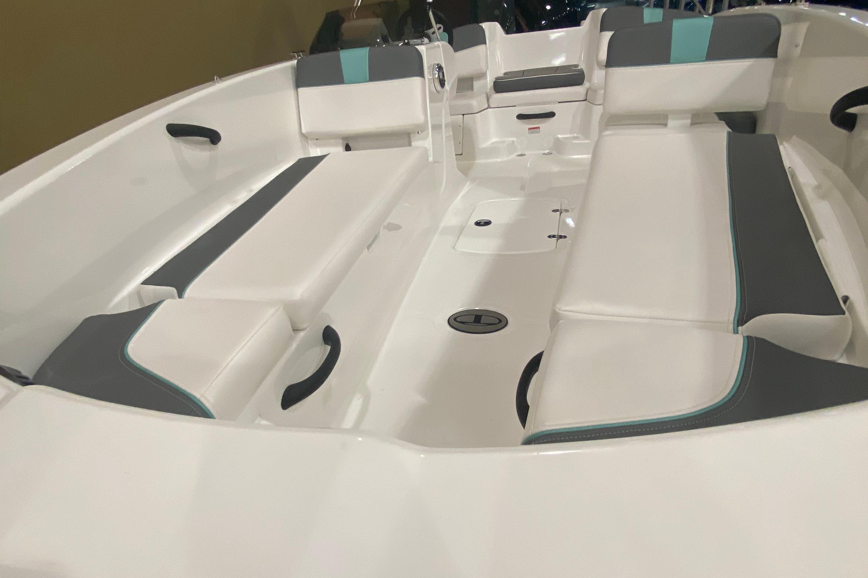 2026 Tahoe T18 boat interior with white and gray seating, featuring teal accents.