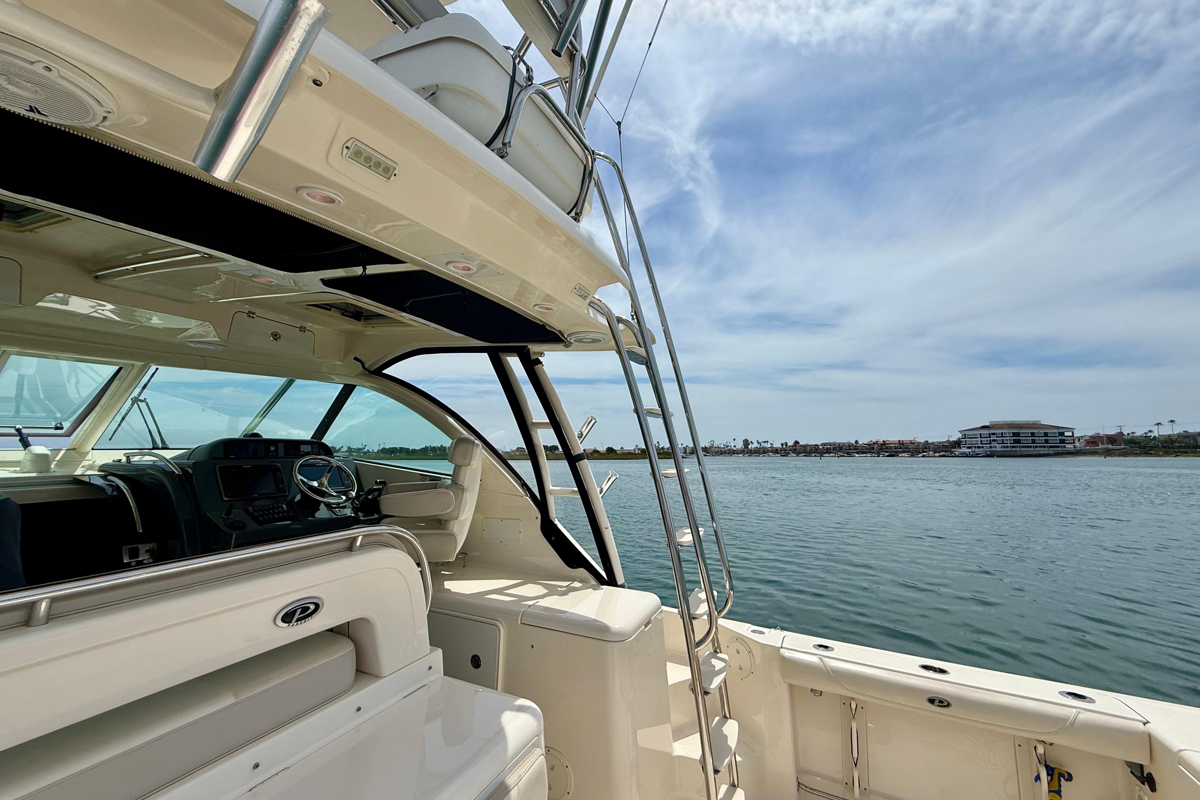 2012 Pursuit OS 345 Offshore boat interior with ocean view and clear sky.