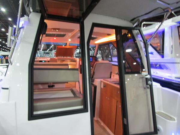 2025 Cutwater C-248 Coupe interior with modern seating and kitchenette.