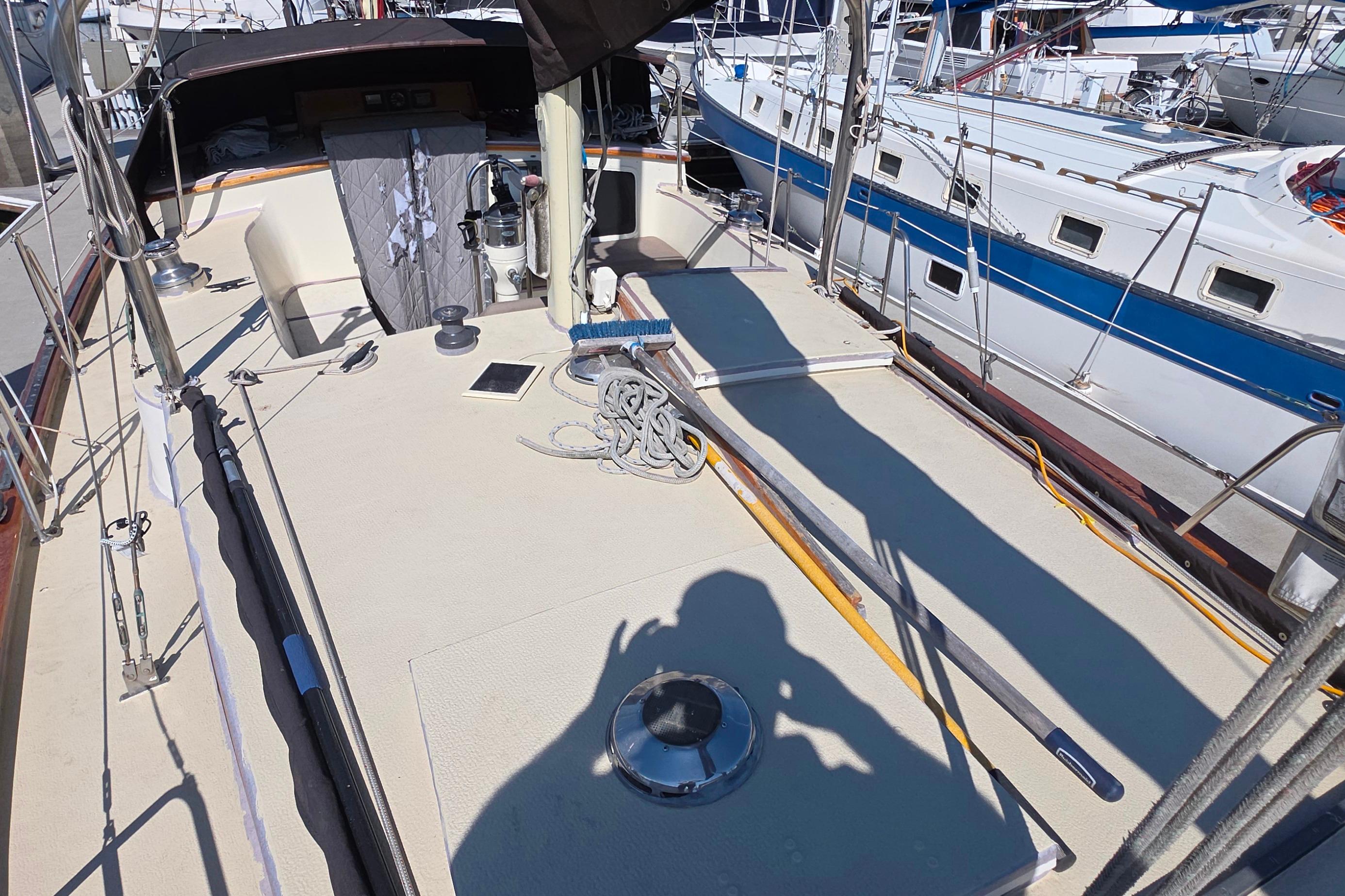 Deck view of a 1978 Islander Freeport 41 sailboat in a marina.