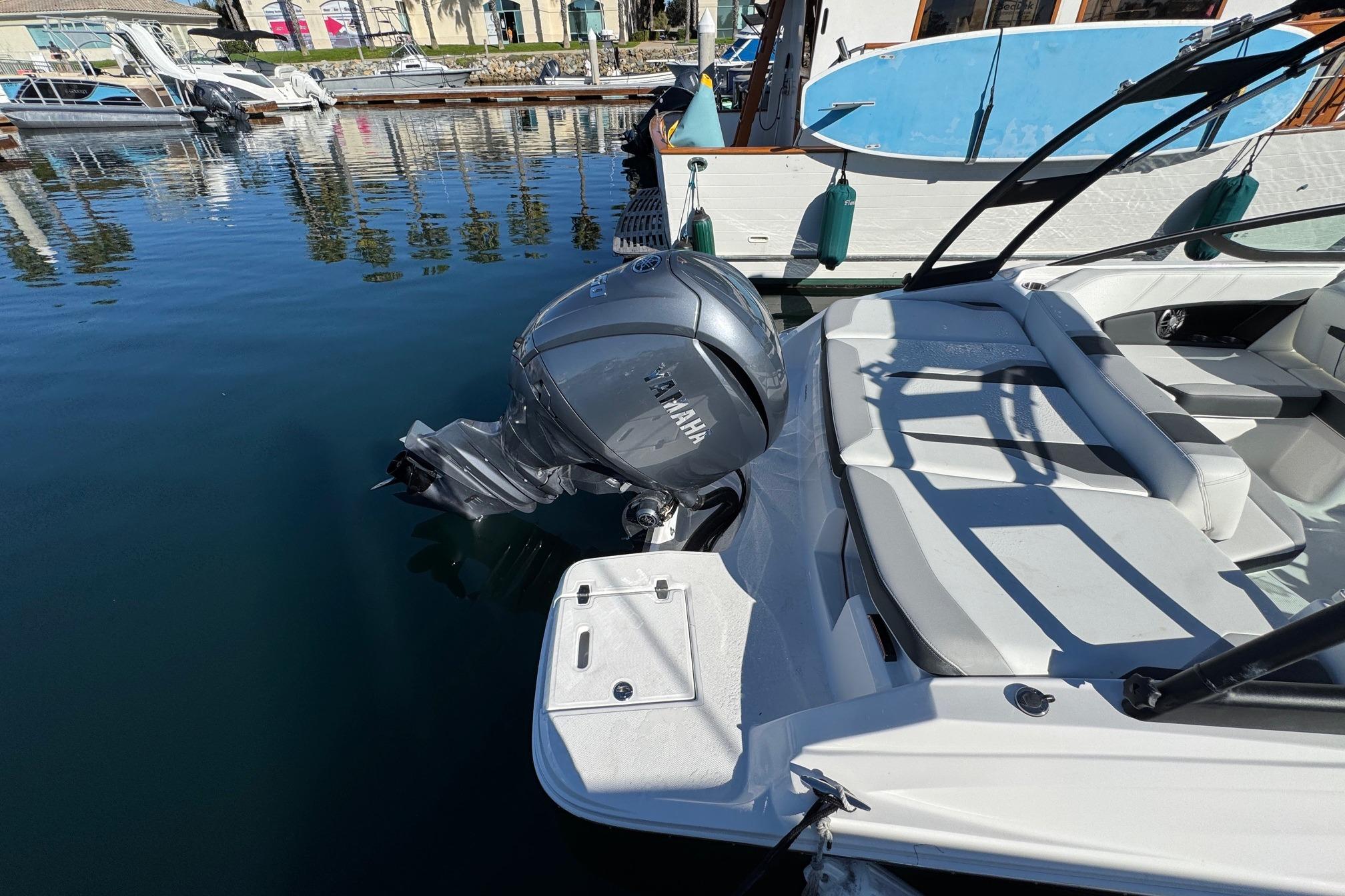 2026 Regal 21 OBX boat with Yamaha outboard motor docked in marina.