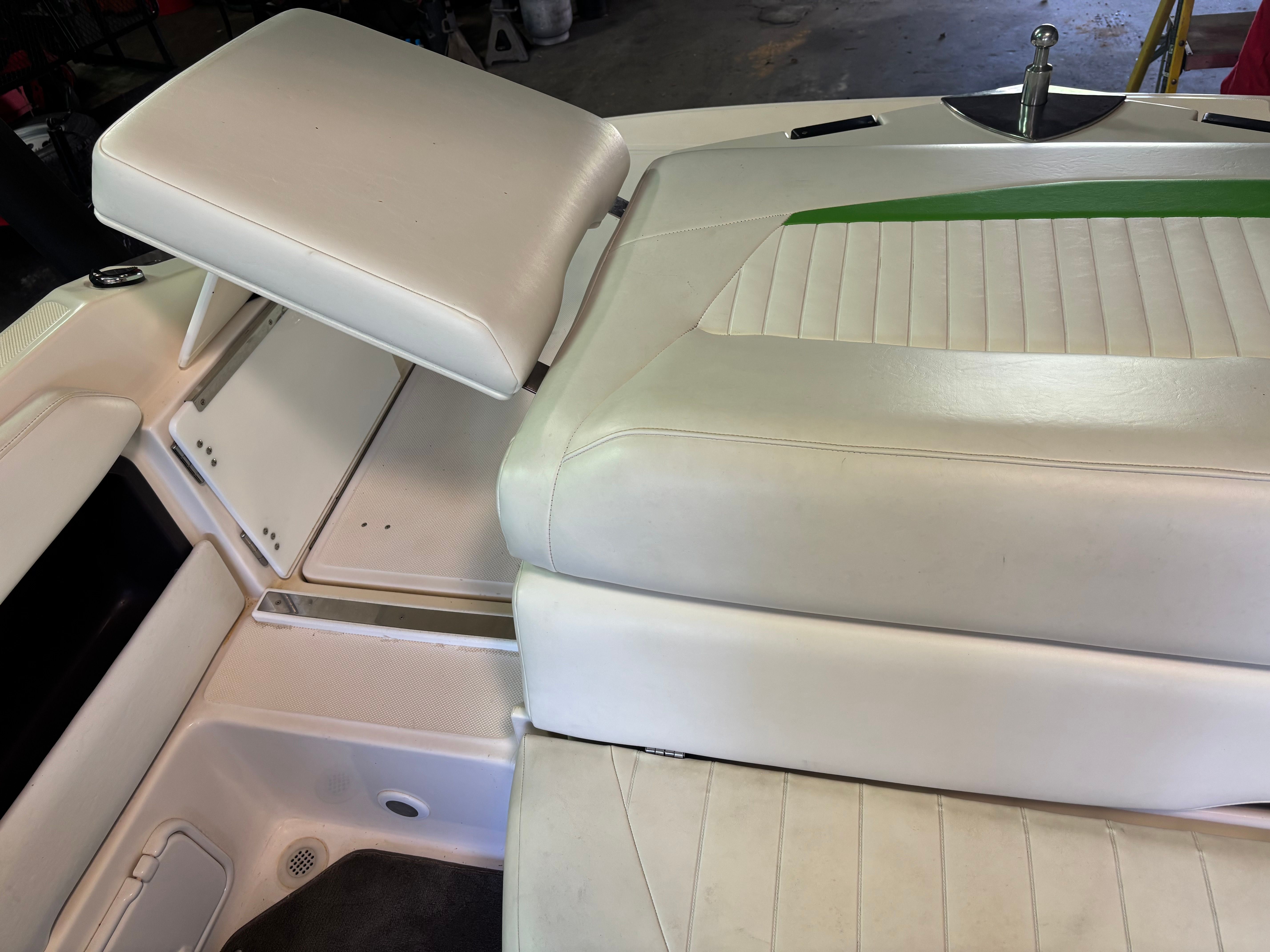 The image shows white upholstery of a boat seat with a green accent.