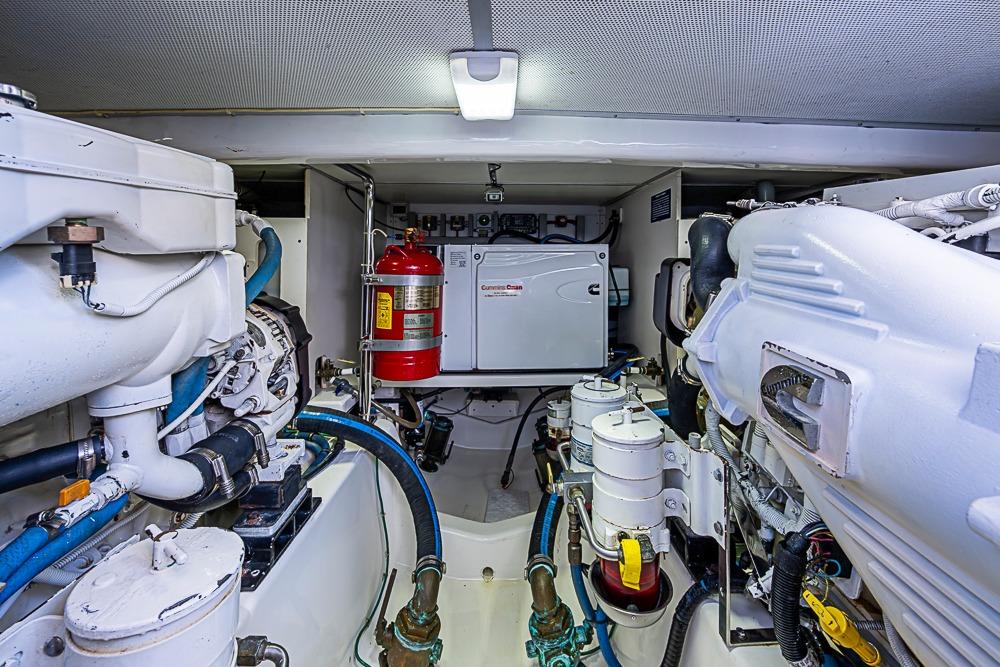 Engine room of 2013 Grand Banks 43 Europa yacht, featuring mechanical components and fire extinguisher.